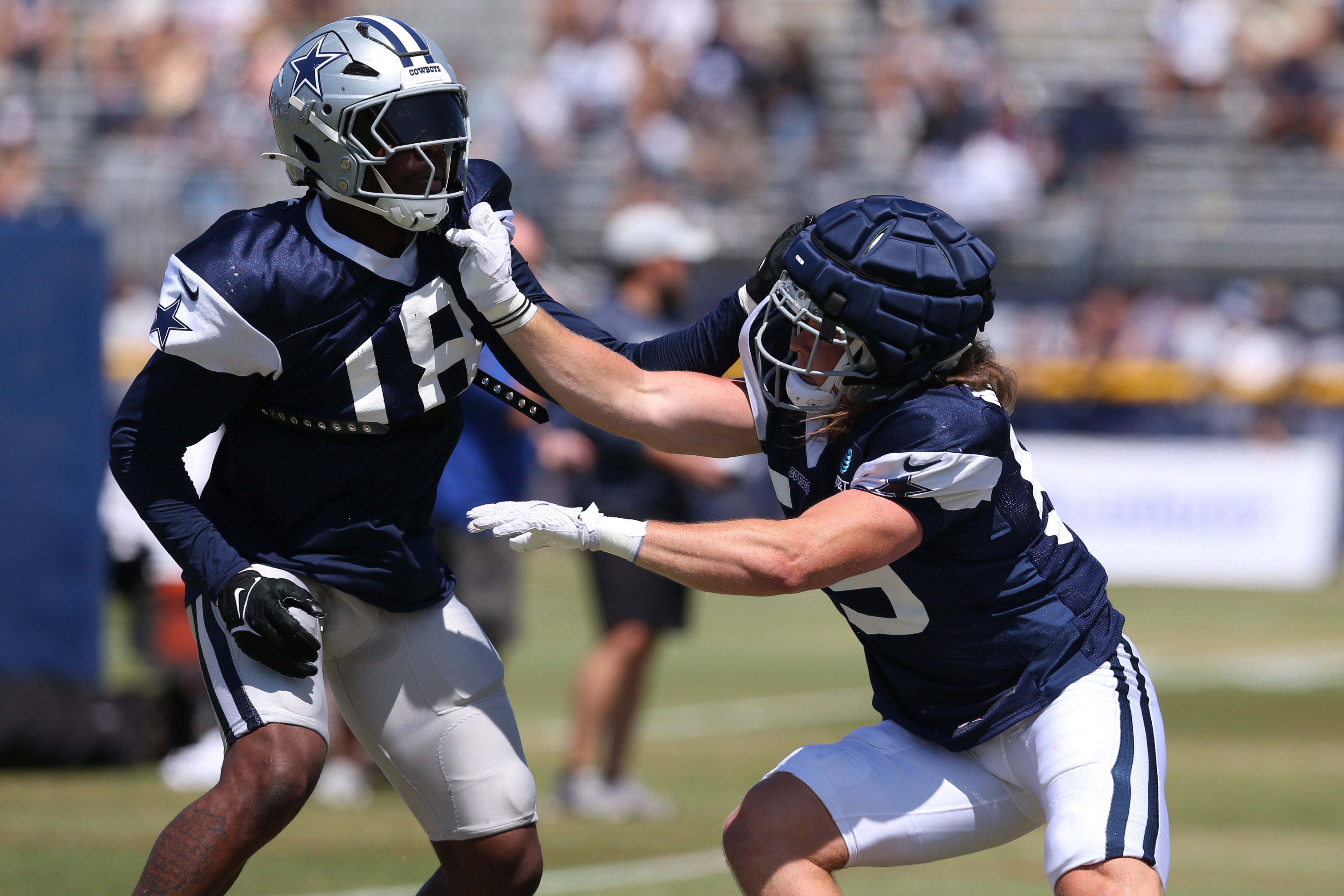 Dallas Cowboys linebacker Damone Clark (18) and linebacker Brock Mogensen (59) block during training camp at the River Ridge Playing Fields in Oxnard, California.