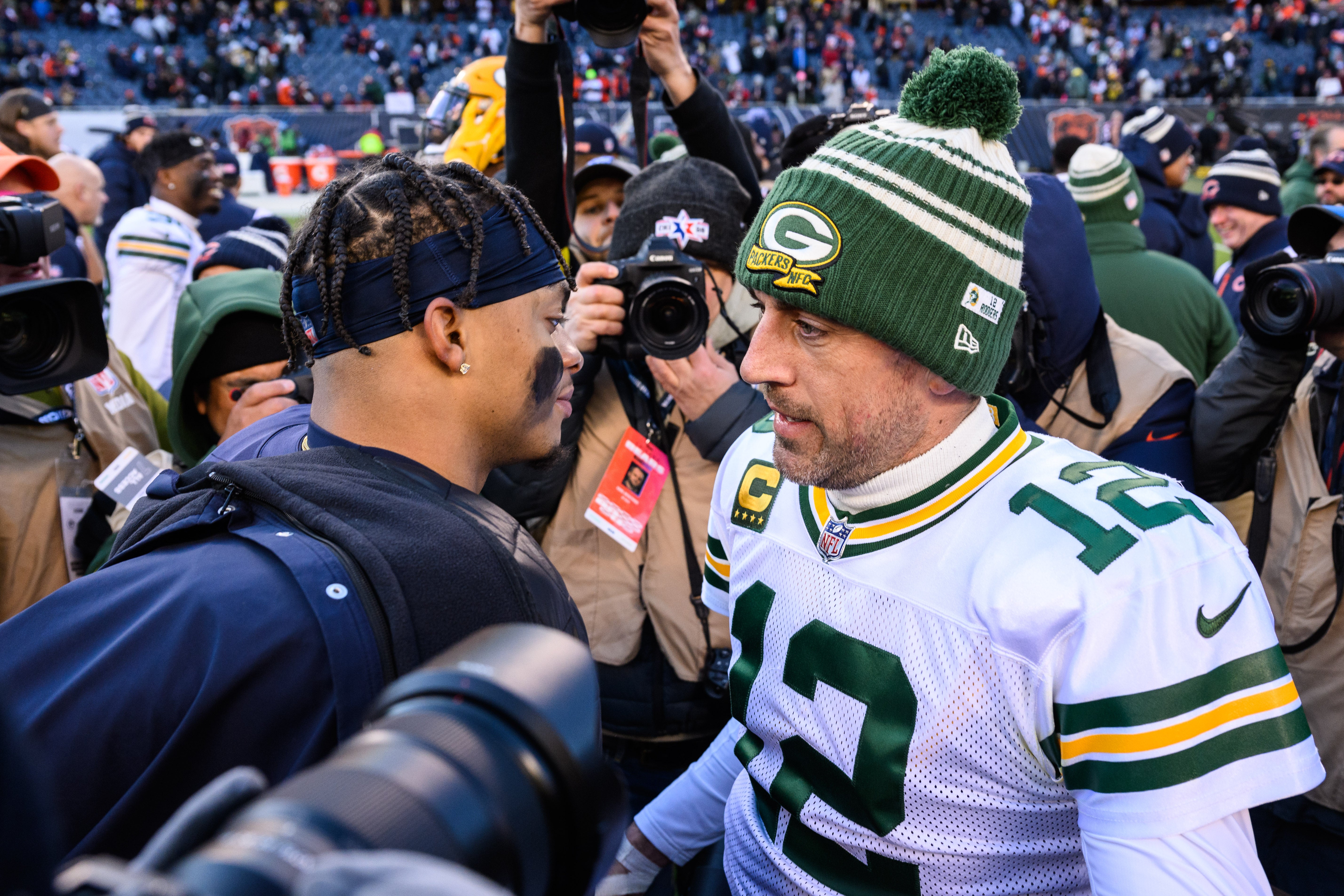 Chicago Bears quarterback Justin Fields (1) and Green Bay Packers quarterback Aaron Rodgers (12) meet on the field after the game at Soldier Field.