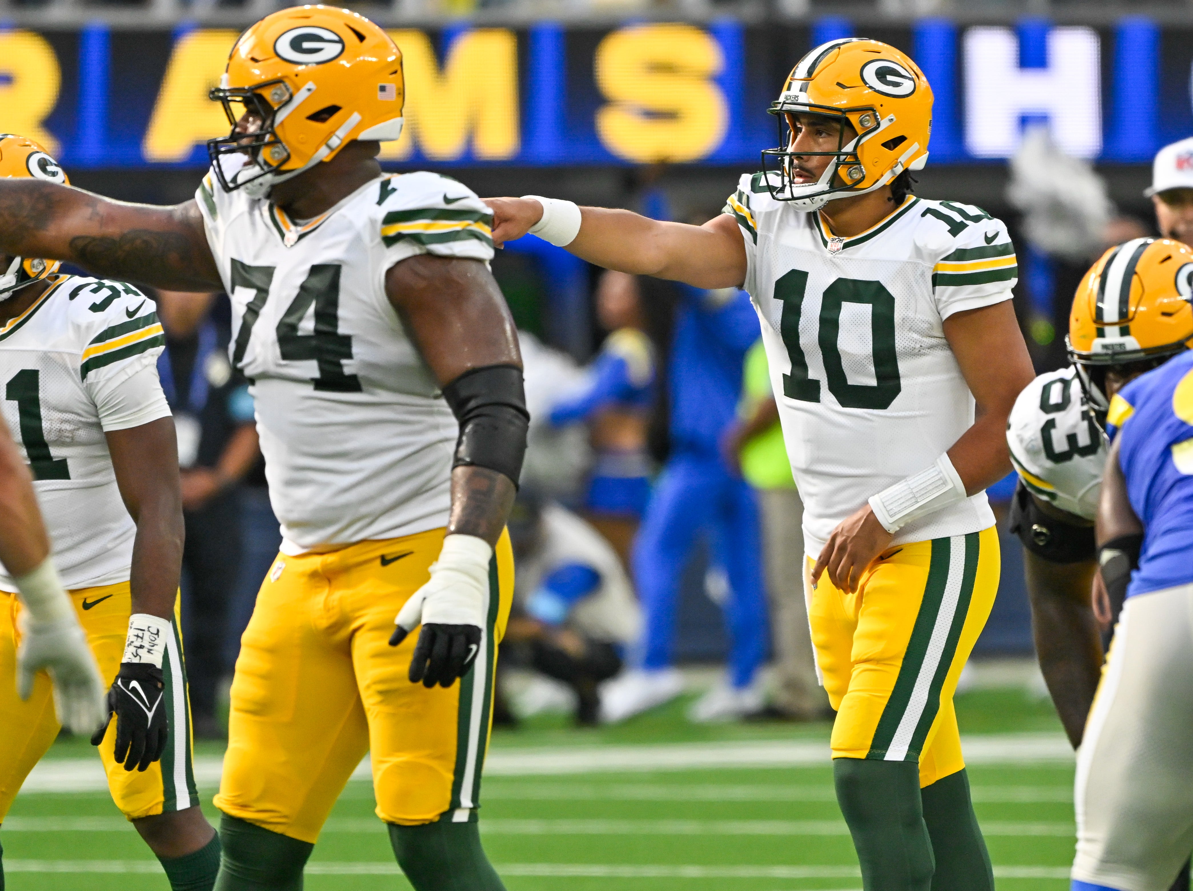 Green Bay Packers guard Elgton Jenkins (74) and Green Bay Packers quarterback Jordan Love (10) during the third quarter against the Los Angeles Rams at SoFi Stadium.