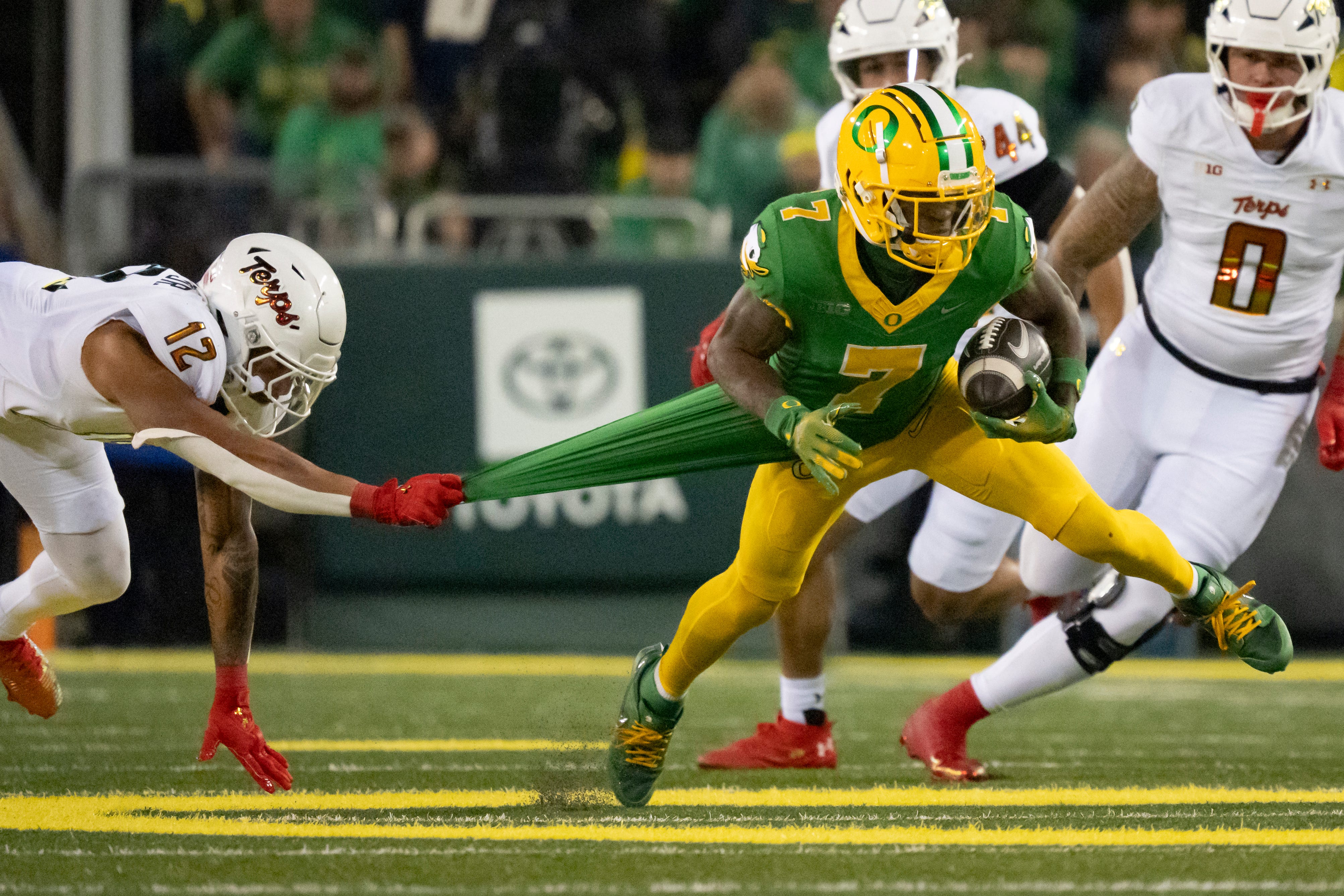 Oregon wide receiver Evan Stewart attempts to avoid a tackle from Maryland defensive back Dante Trader Jr. as the Oregon Ducks host the Maryland Terrapins at Autzen Stadium Saturday, Nov. 9, 2024 in Eugene, Ore.