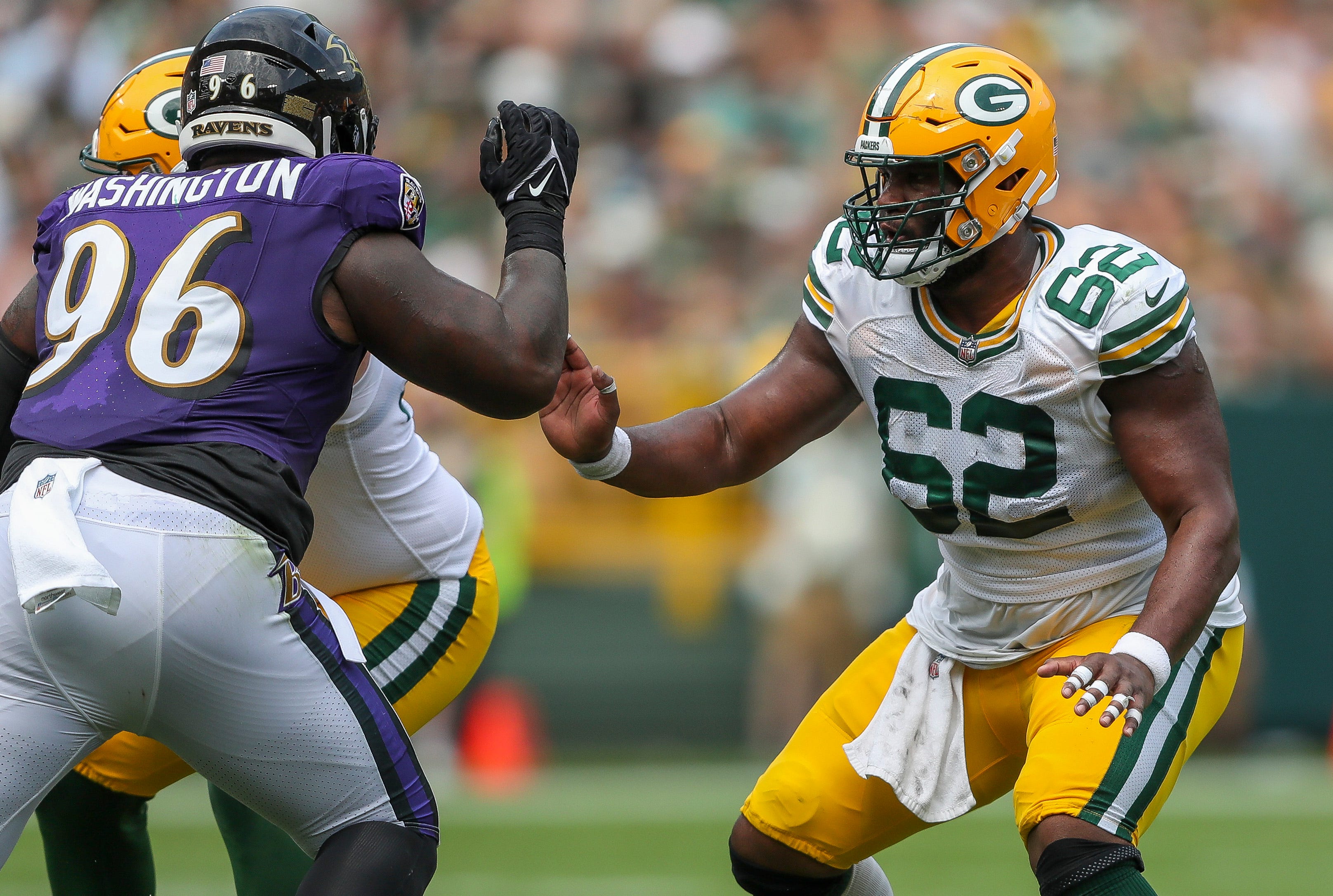 Green Bay Packers center Jacob Monk (62) blocks Baltimore Ravens defensive lineman Broderick Washington (96) during an NFL preseason game on Saturday, August 24, 2024, at Lambeau Field in Green Bay, Wis.