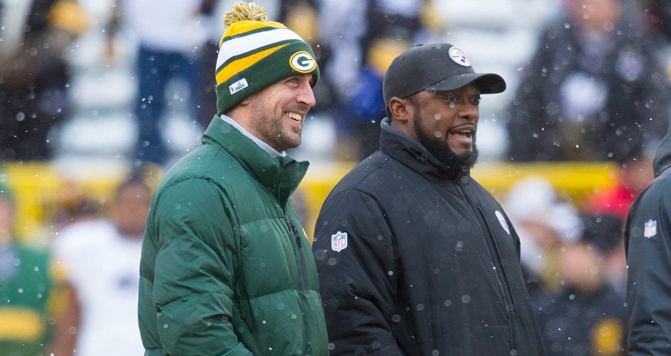 Dec 22, 2013; Green Bay, WI, USA; Green Bay Packers quarterback Aaron Rodgers and Pittsburgh Steelers head coach Mike Tomlin talk during warmups prior to the game at Lambeau Field.
