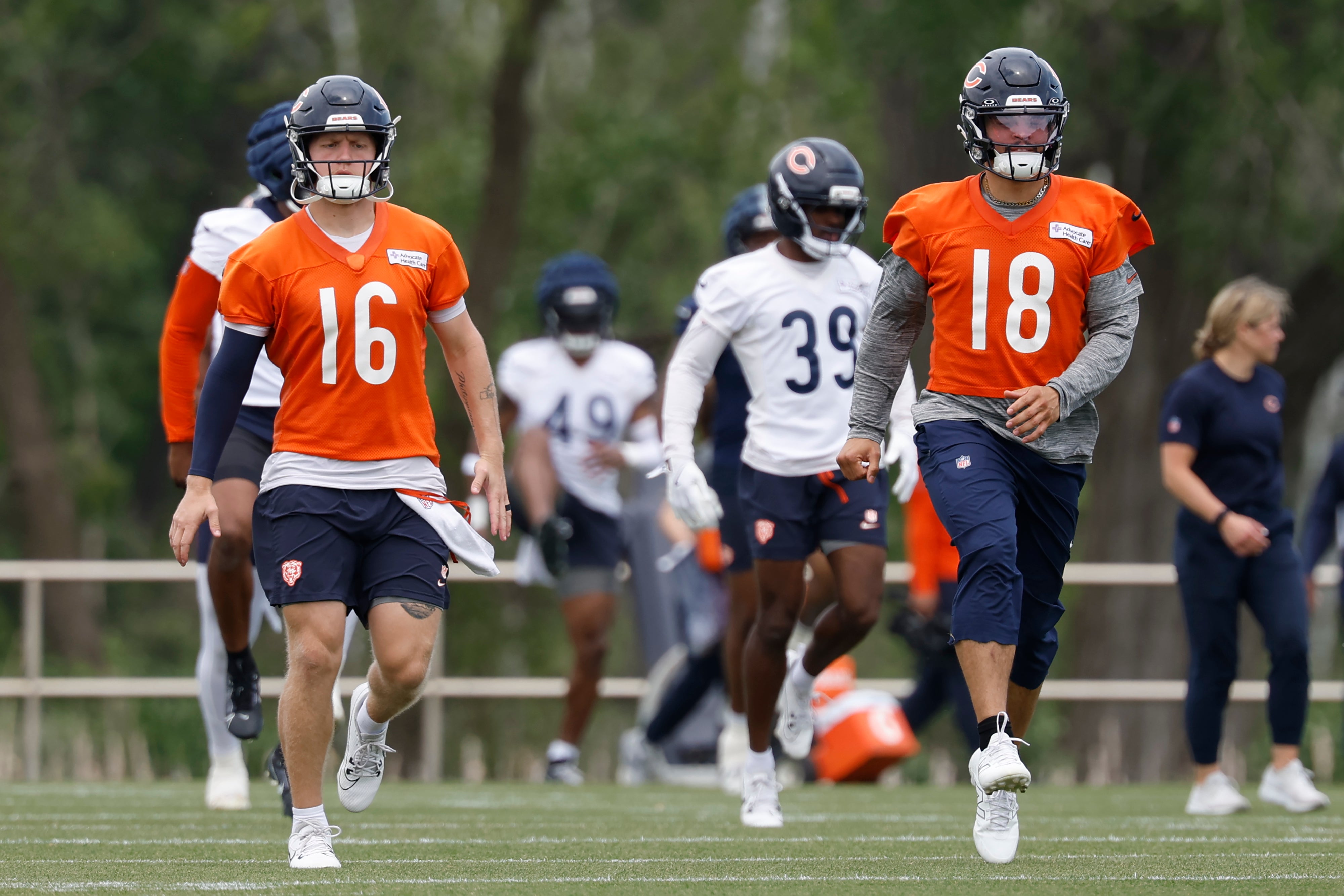 Austin Reed (16) and quarterback Caleb Williams (18) warm up during minicamp at Halas Hall.