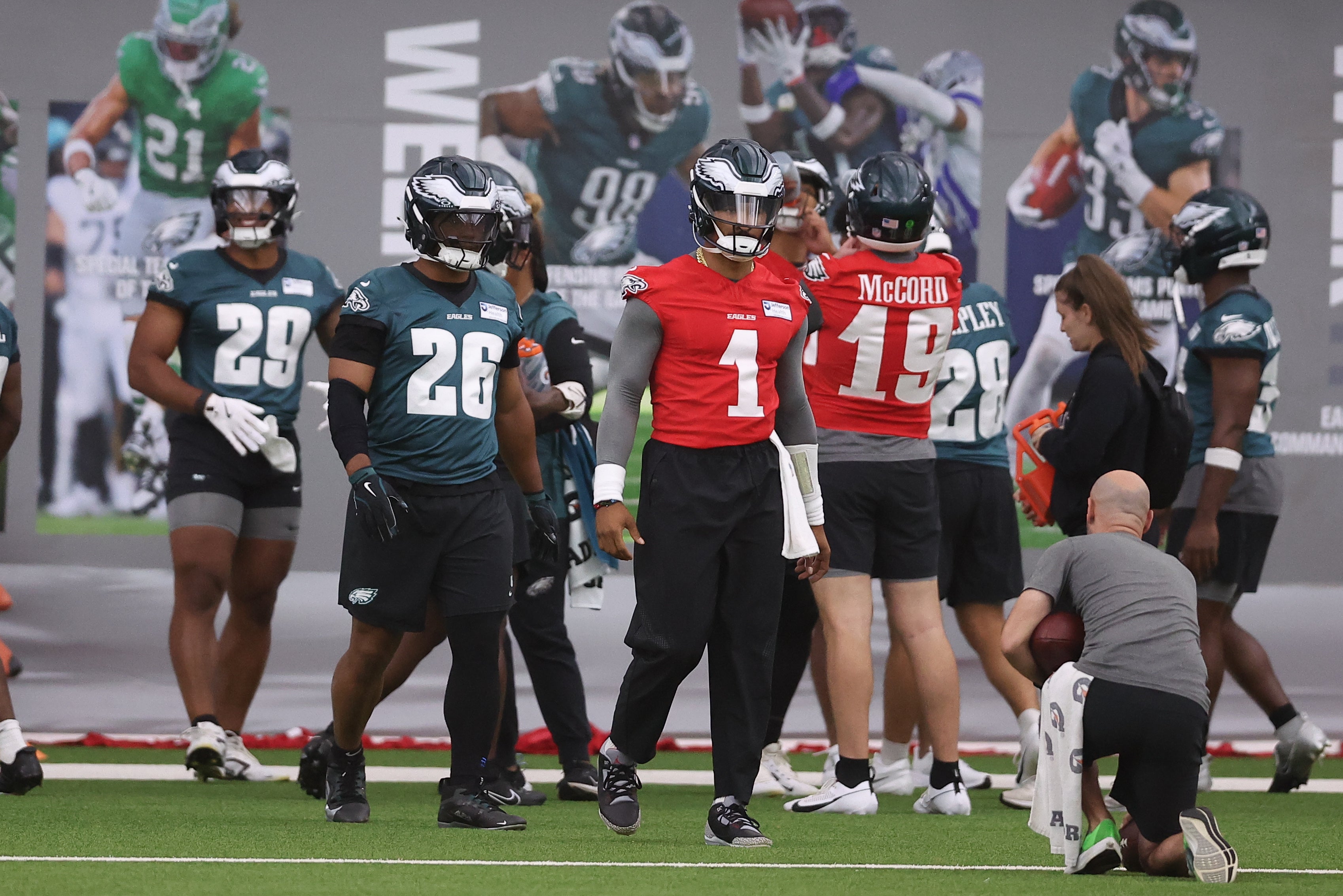 Philadelphia Eagles quarterback Jalen Hurts (1) andrunning back Saquon Barkley (26) prepare to run a drill during OTAs at NovaCare Complex.