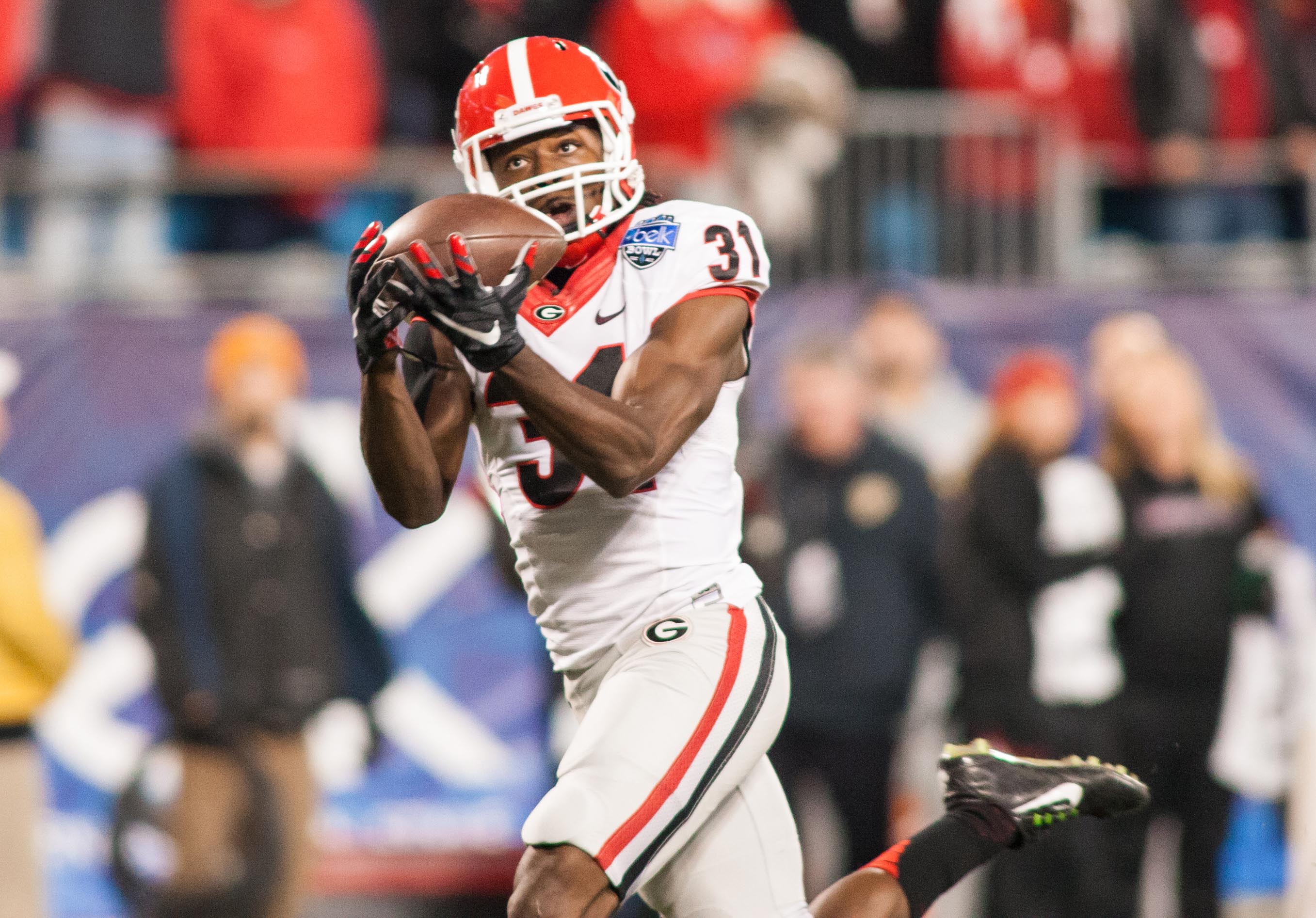 Georgia Bulldogs wide receiver Chris Conley (31) catches a pass for a touchdown during the first quarter against the Louisville Cardinals of the Belk Bowl held at Bank of America Stadium.