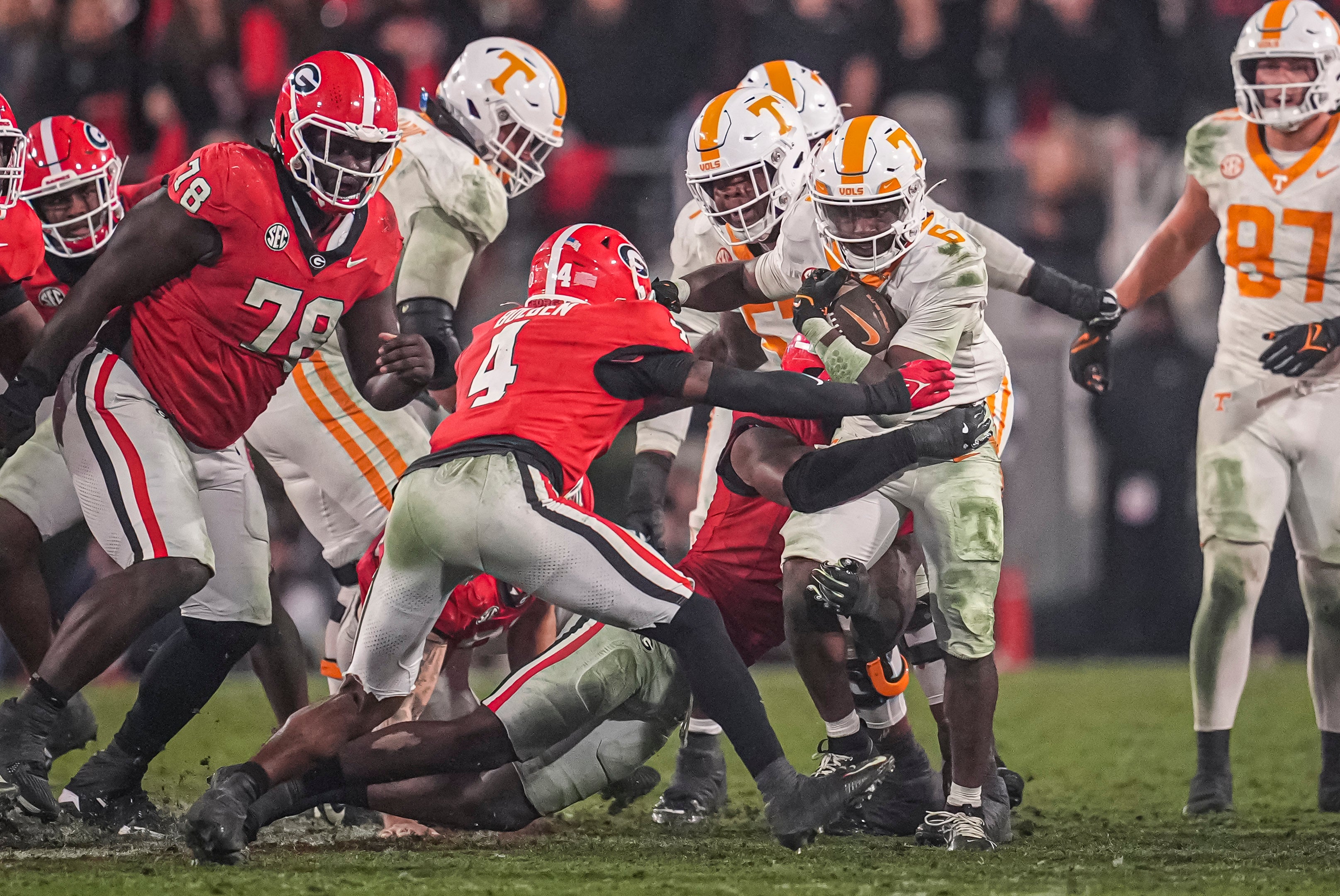 Tennessee Volunteers running back Dylan Sampson (6) runs against Georgia Bulldogs defensive back KJ Bolden (4) during the second half at Sanford Stadium.