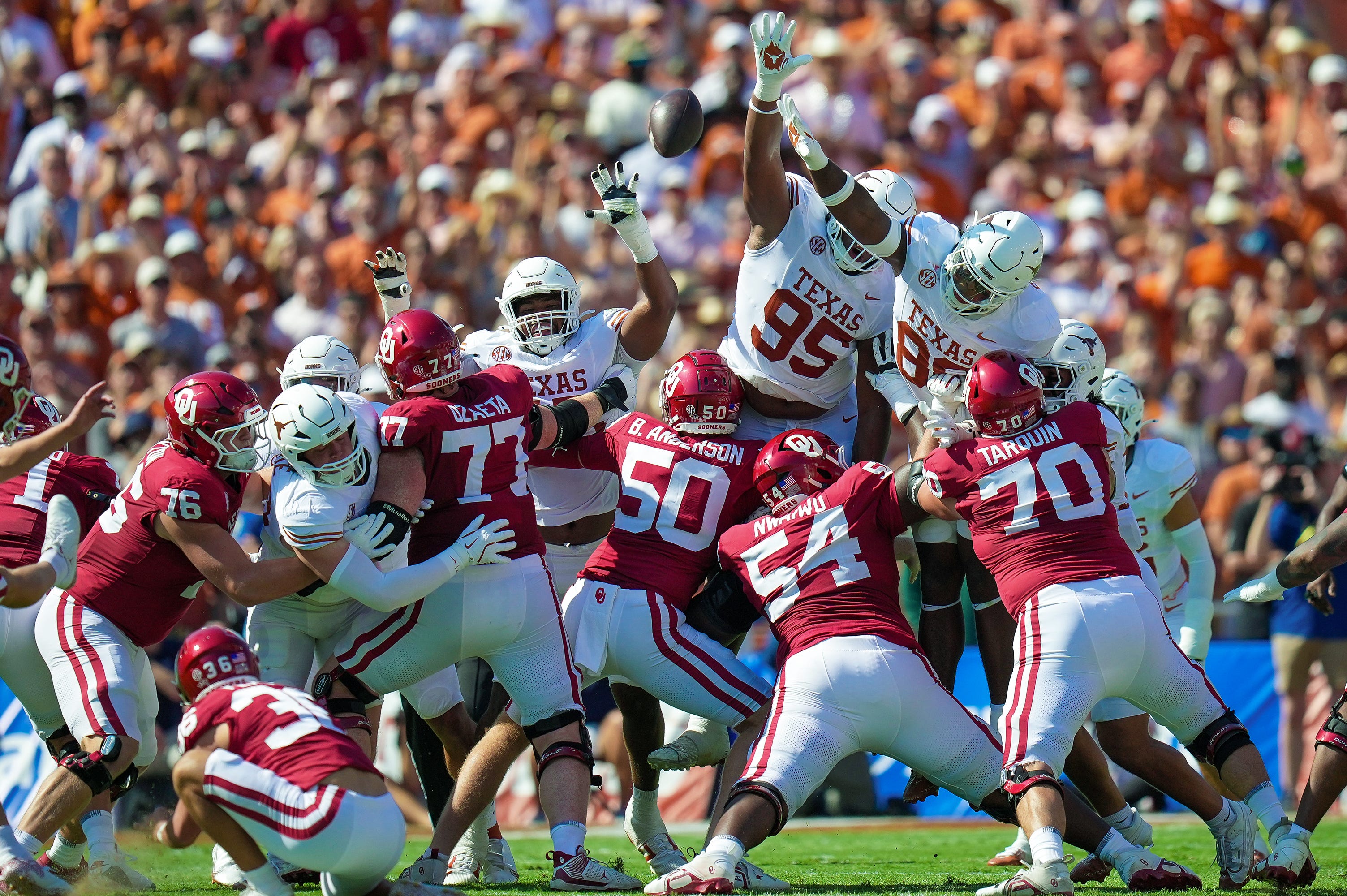Texas Longhorns defensive lineman Alfred Collins (95) and Texas Longhorns defensive lineman Tiaoalii Savea (98) tries to block the field goal in the first quarter during the Red River Rivalry Football Game between the University of Oklahoma Sooners and the University of Texas Longhorns at the Cotton Bowl Stadium in Dallas, TX on Saturday Oct. 12, 2024.