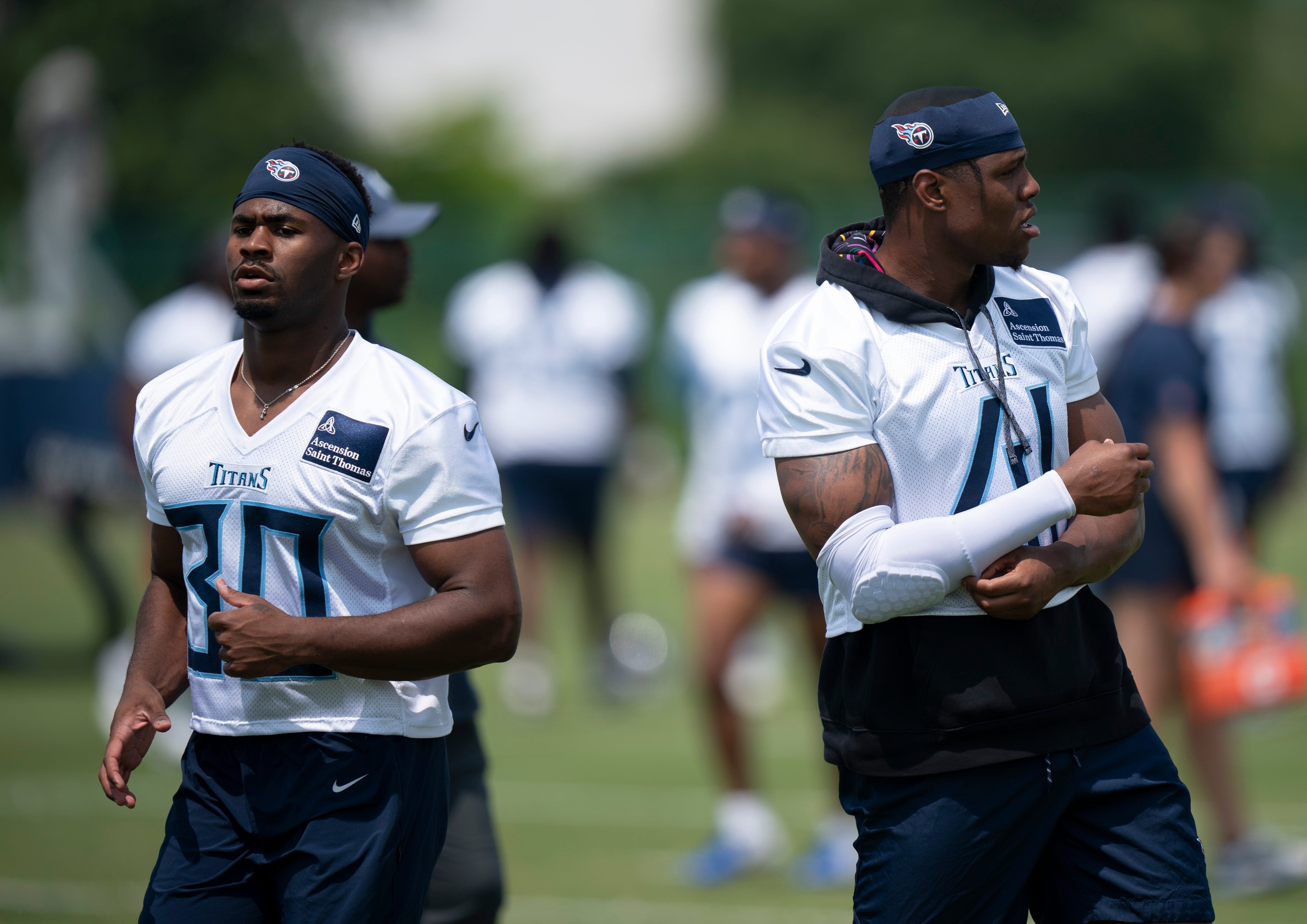 Tennessee Titans Mark Perry (30) and Otis Reese IV (41) start their stretching during OTAs at Ascension Saint Thomas Sports Park in Nashville, Tenn., Tuesday, June 3, 2025.