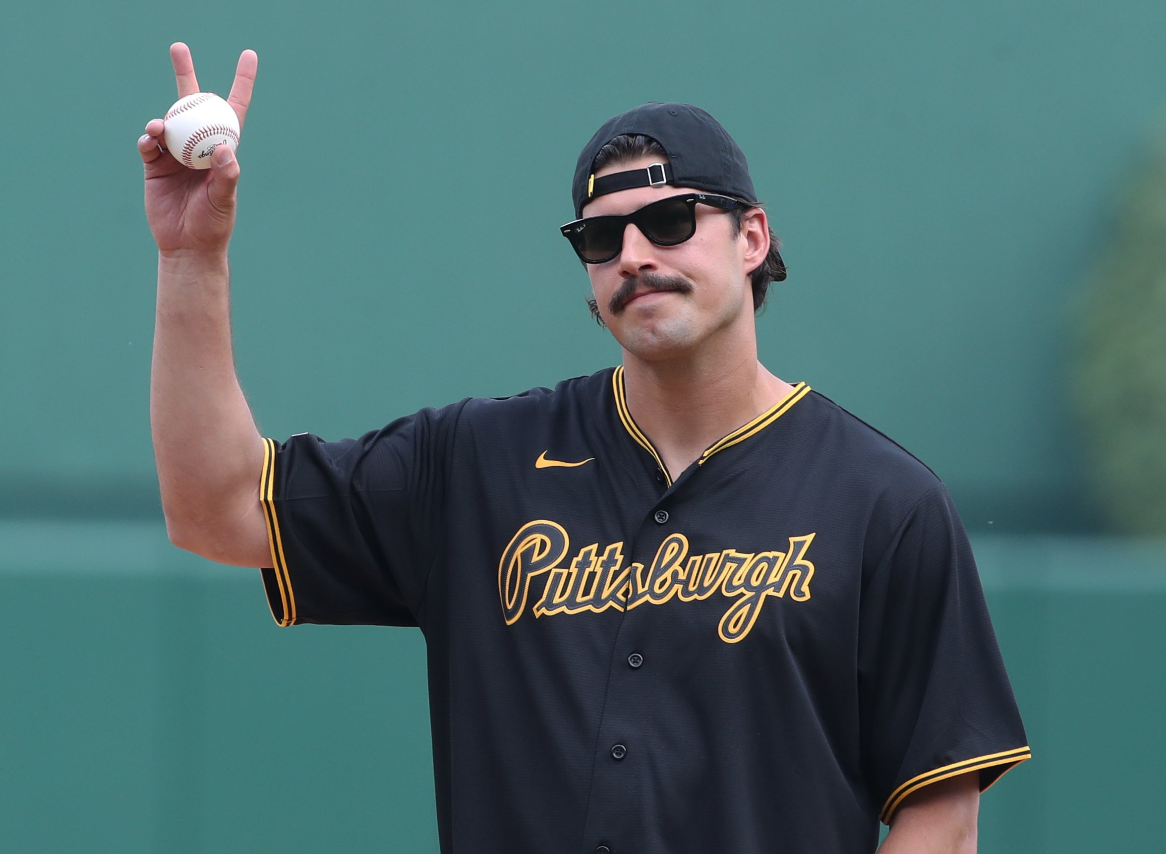 Jun 7, 2025; Pittsburgh, Pennsylvania, USA; Pittsburgh Steelers quarterback Mason Rudolph (2) gestures before throwing out a ceremonial first pitch prior to the Pittsburgh Pirates playing the Philadelphia Phillies at PNC Park.