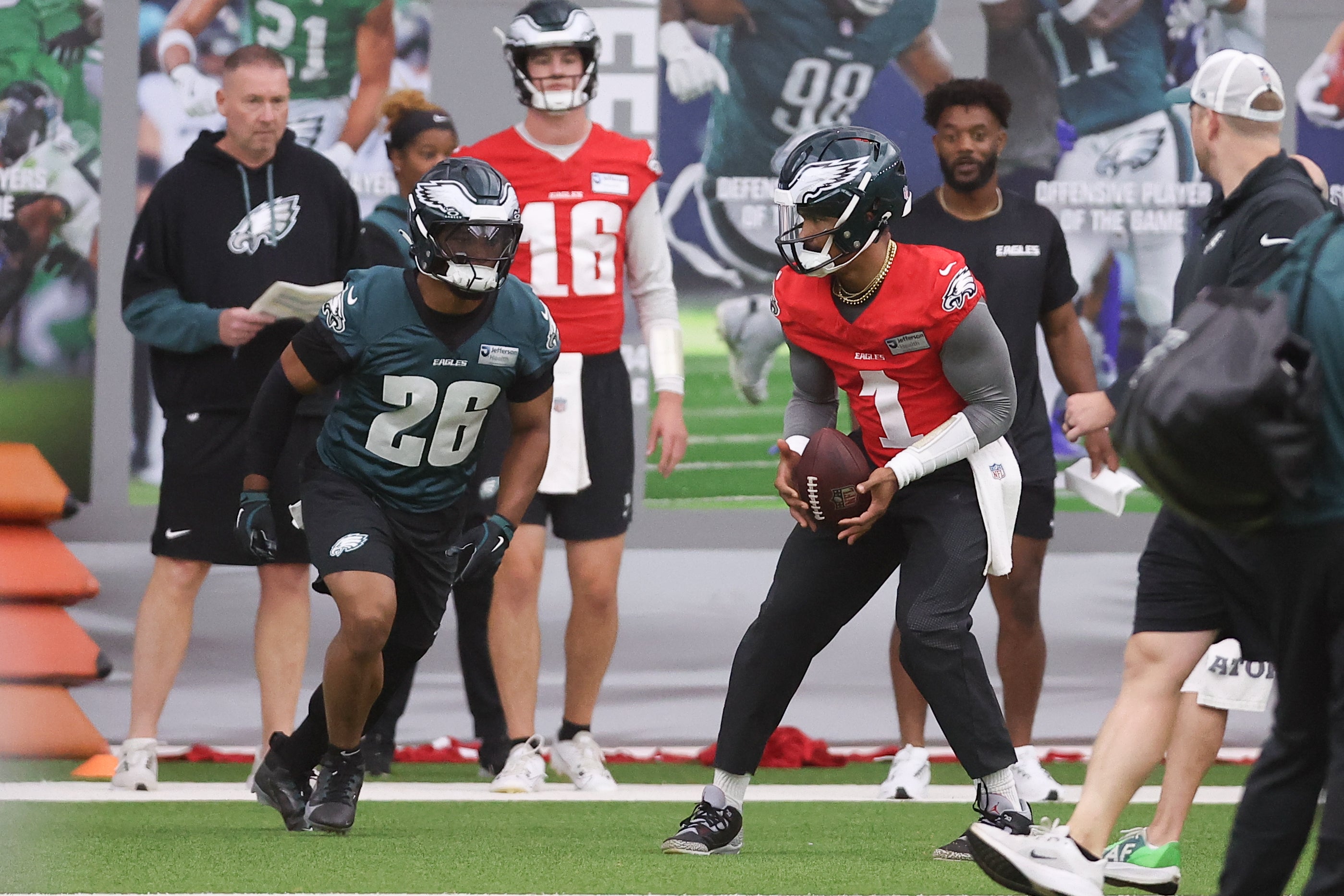 Philadelphia Eagles quarterback Jalen Hurts (1) hands off to running back Saquon Barkley (26) during OTAs at NovaCare Complex.