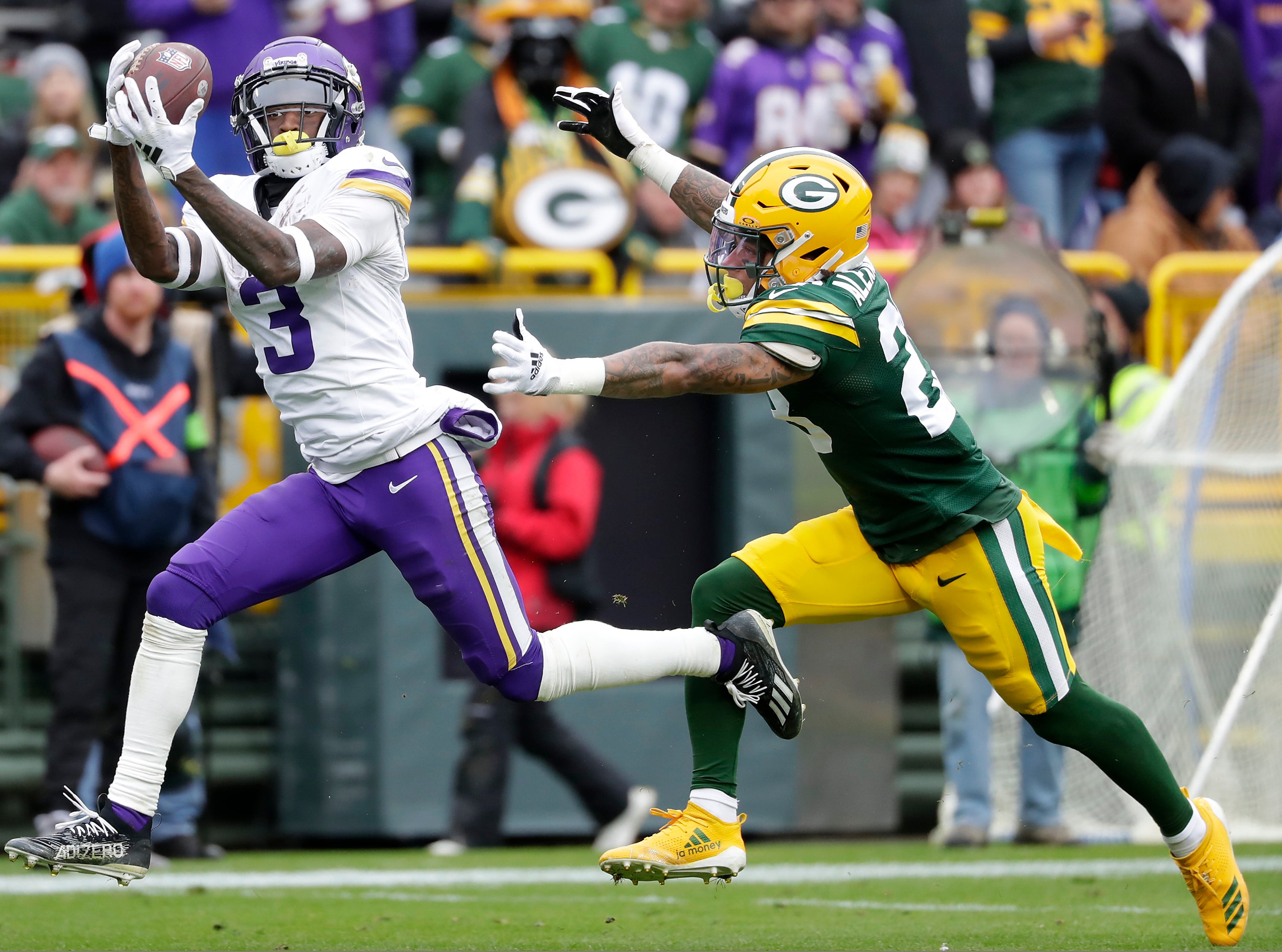Oct 29, 2023; Green Bay, Wisconsin, USA; Minnesota Vikings wide receiver Jordan Addison (3) catches a pass against Green Bay Packers cornerback Jaire Alexander (23) during their football game at Lambeau Field.