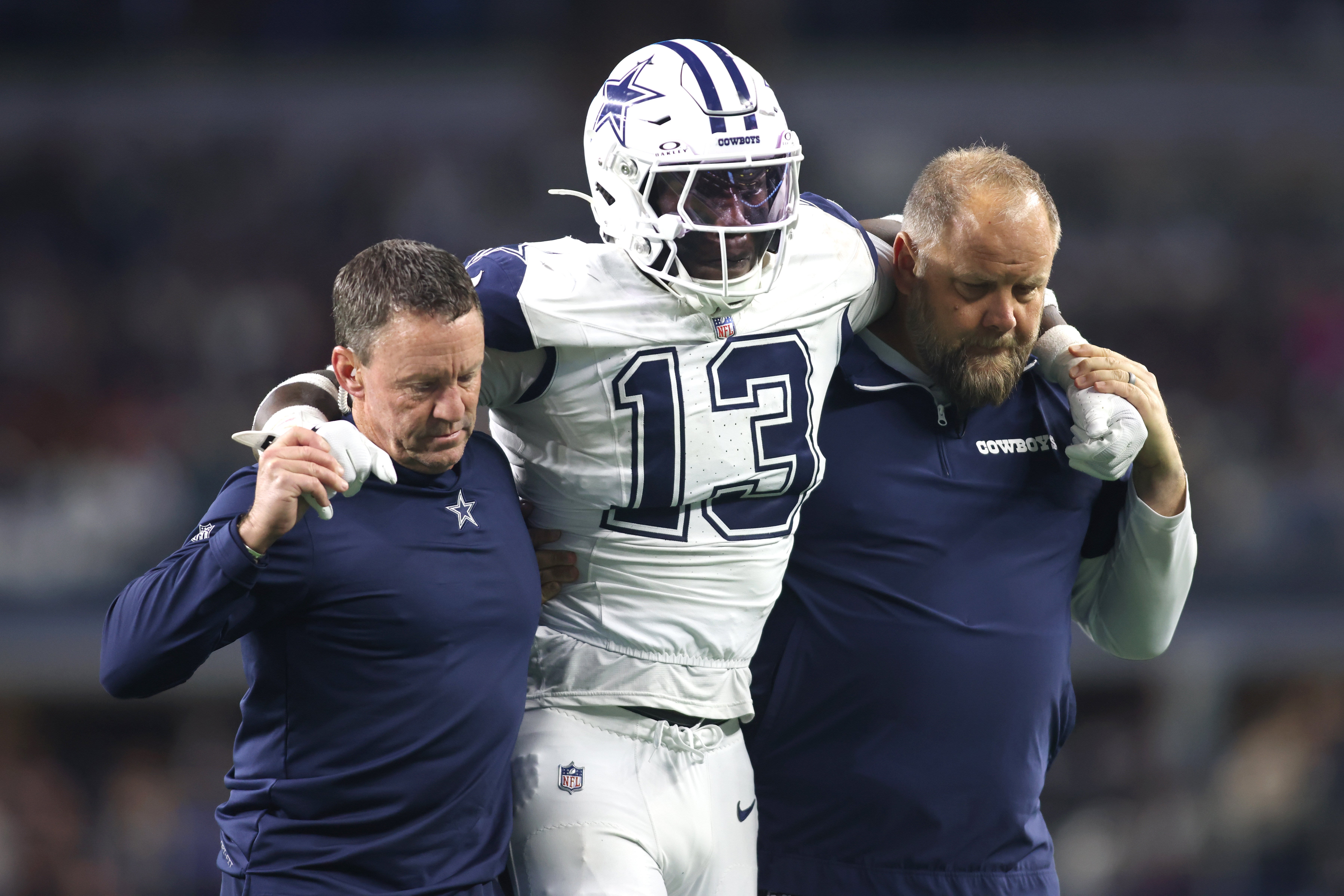 Dallas Cowboys linebacker DeMarvion Overshown (13) is helped off the field after an injury in the second half against the Cincinnati Bengals at AT&T Stadium.