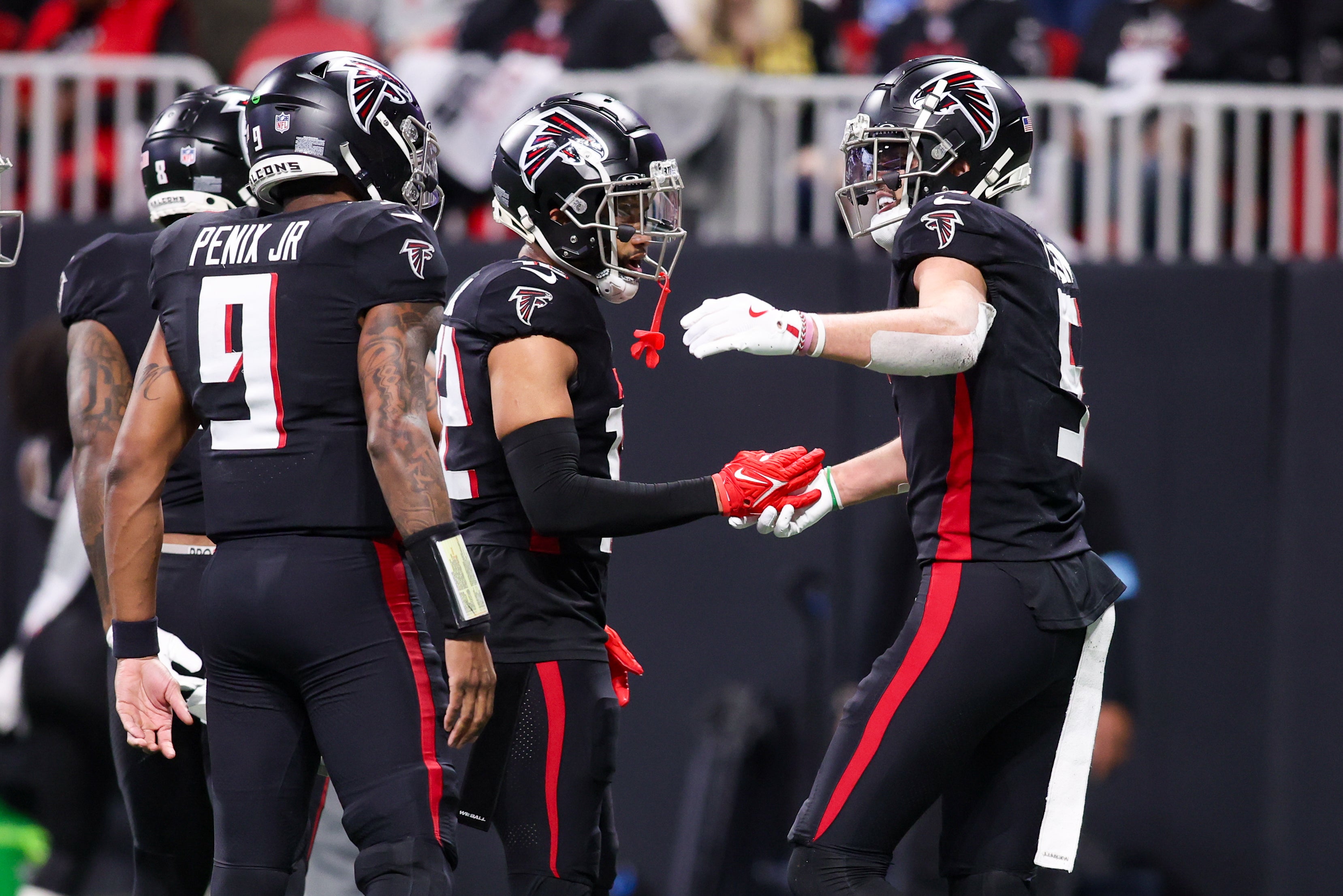 Atlanta Falcons wide receiver Drake London (5) celebrates after a touchdown catch with teammates