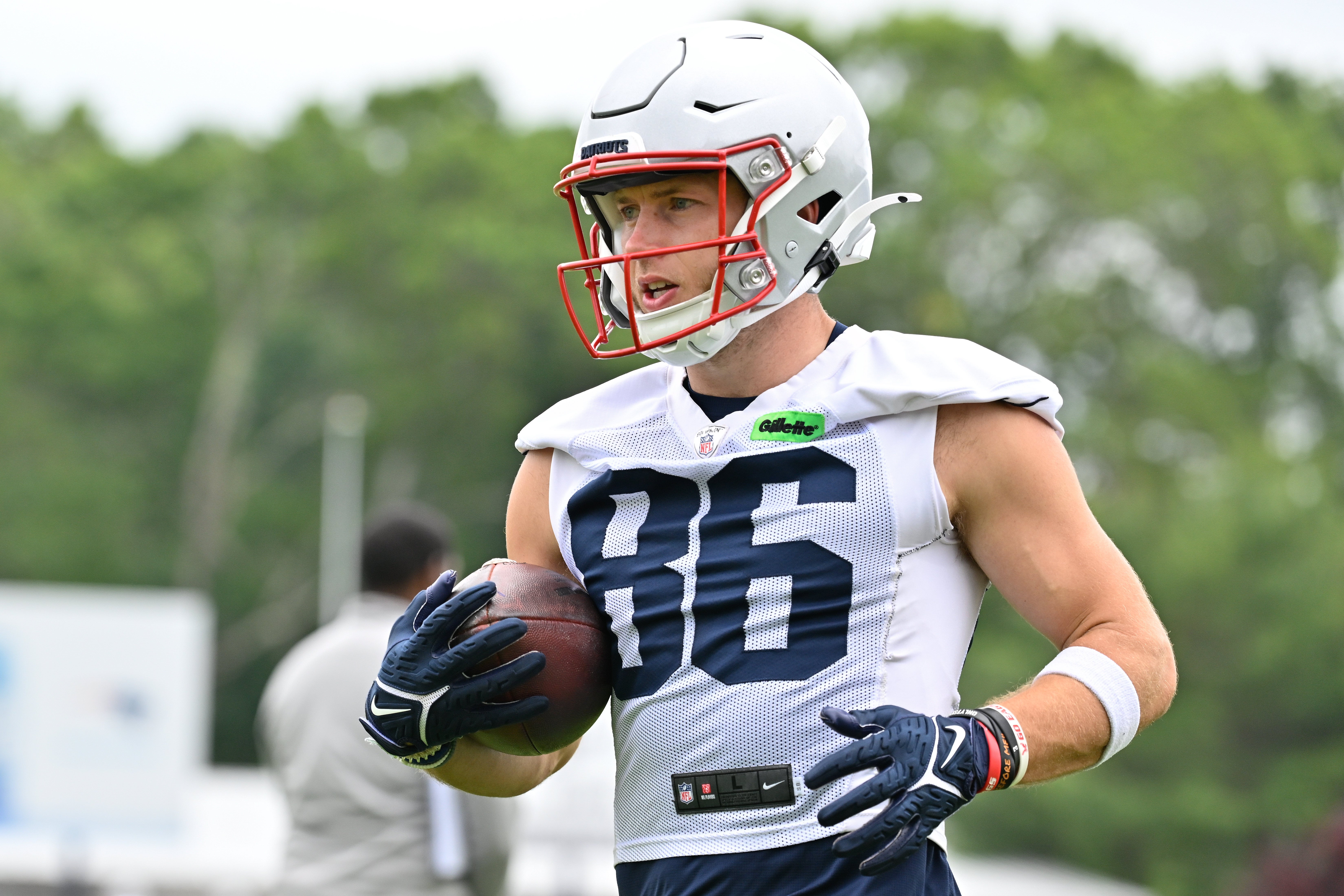 New England Patriots wide receiver Efton Chism III (86) runs the ball after the catch during minicamp at Gillette Stadium.