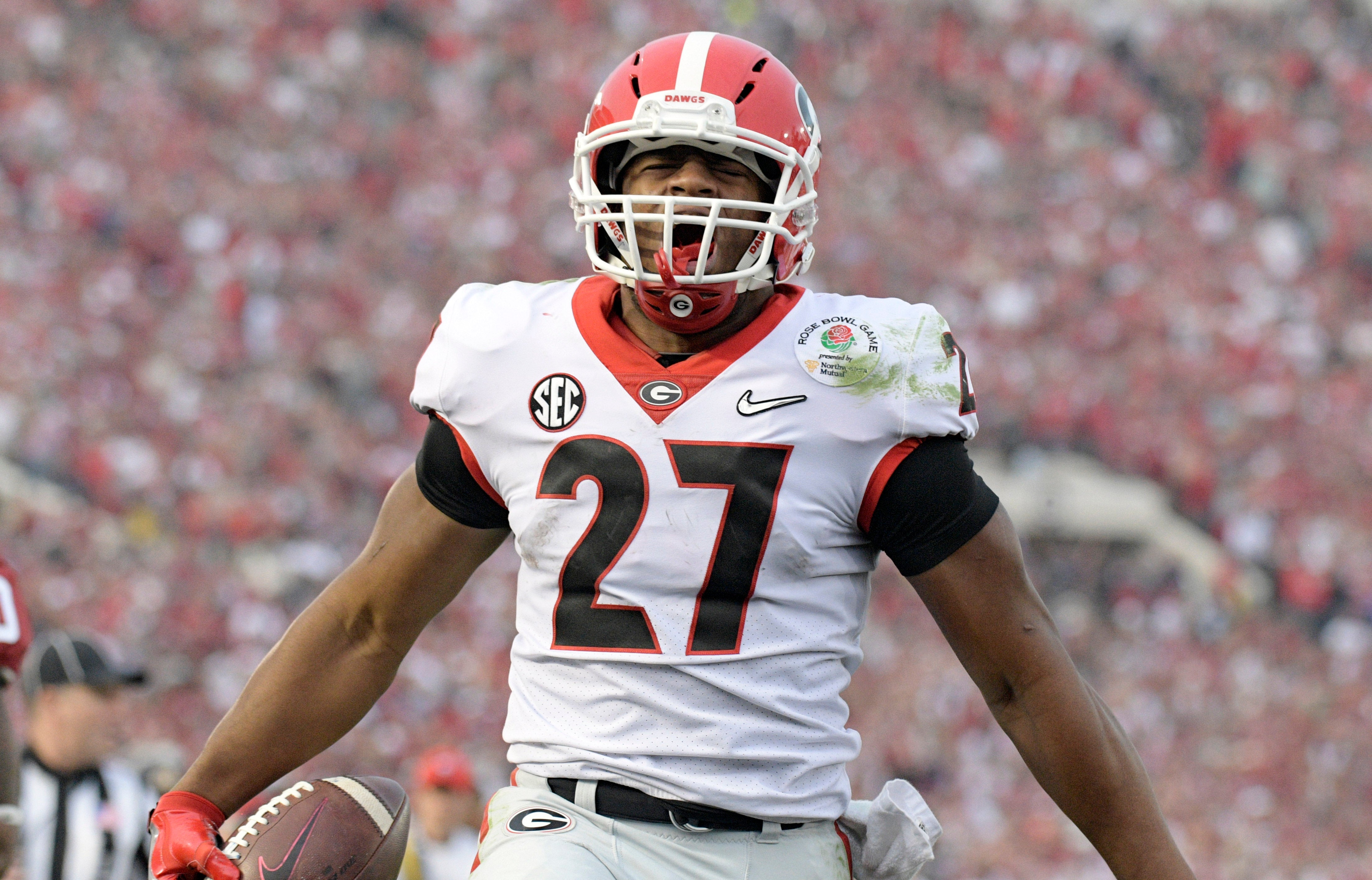 Georgia Bulldogs running back Nick Chubb (27) celebrates scoring a touchdown against the Oklahoma Sooners in the third quarter in the 2018 Rose Bowl college football playoff semifinal game at Rose Bowl.