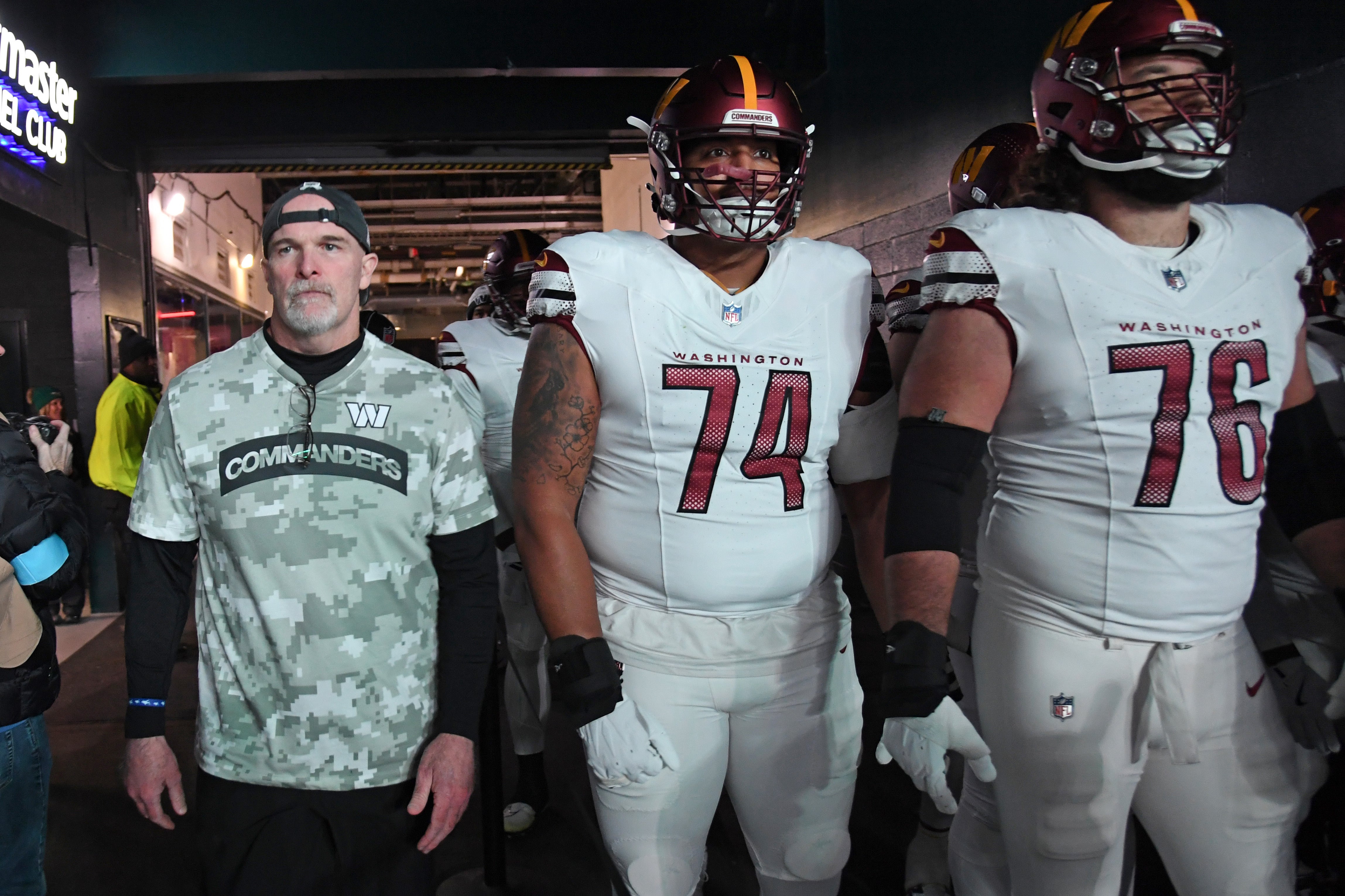 Nov 14, 2024; Philadelphia, Pennsylvania, USA; Washington Commanders head coach Dan Quinn, offensive tackle Brandon Coleman (74) and guard Sam Cosmi (76) against the Philadelphia Eagles at Lincoln Financial Field.