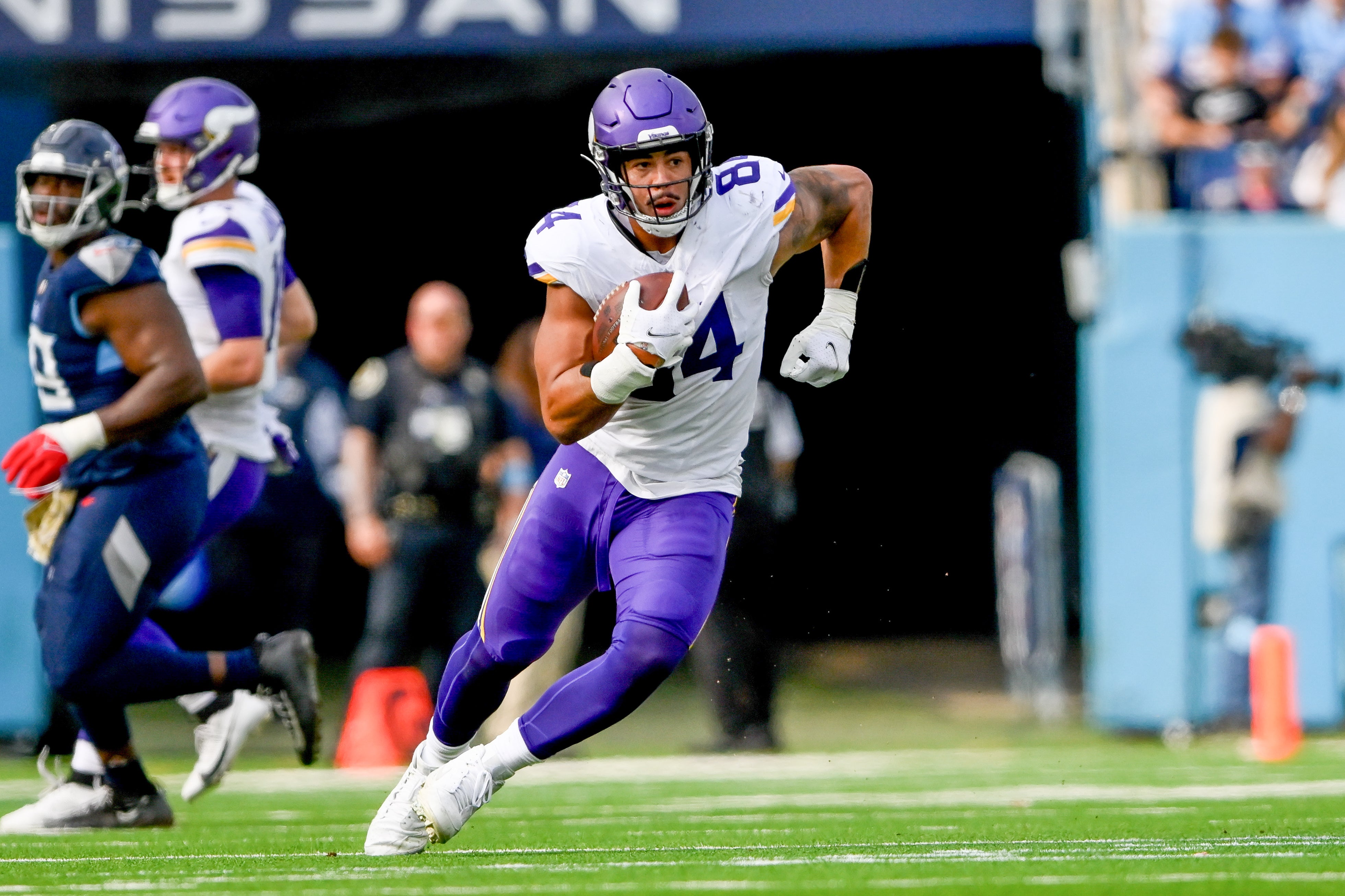 Nov 17, 2024; Nashville, Tennessee, USA; Minnesota Vikings tight end Josh Oliver (84) runs the ball after a made catch against the Tennessee Titans during the first half at Nissan Stadium.
