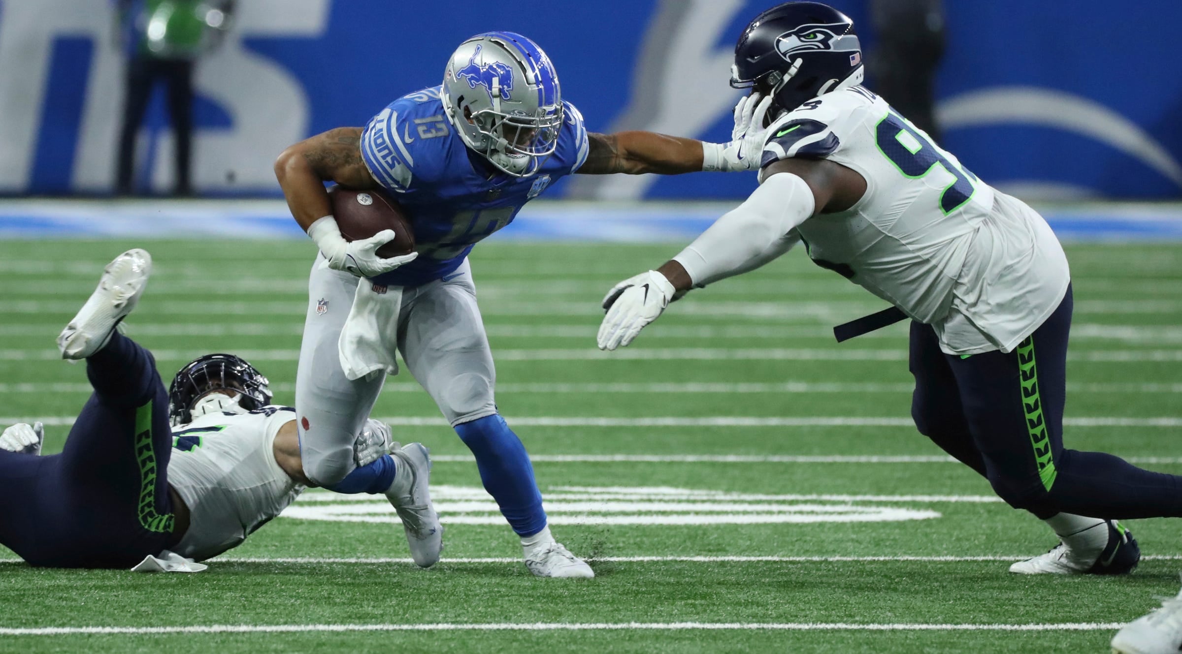 Detroit Lions running back Craig Reynolds (13) is tackled by Seattle Seahawks defensive tackle Cameron Young (93) during the second half at Ford Field.