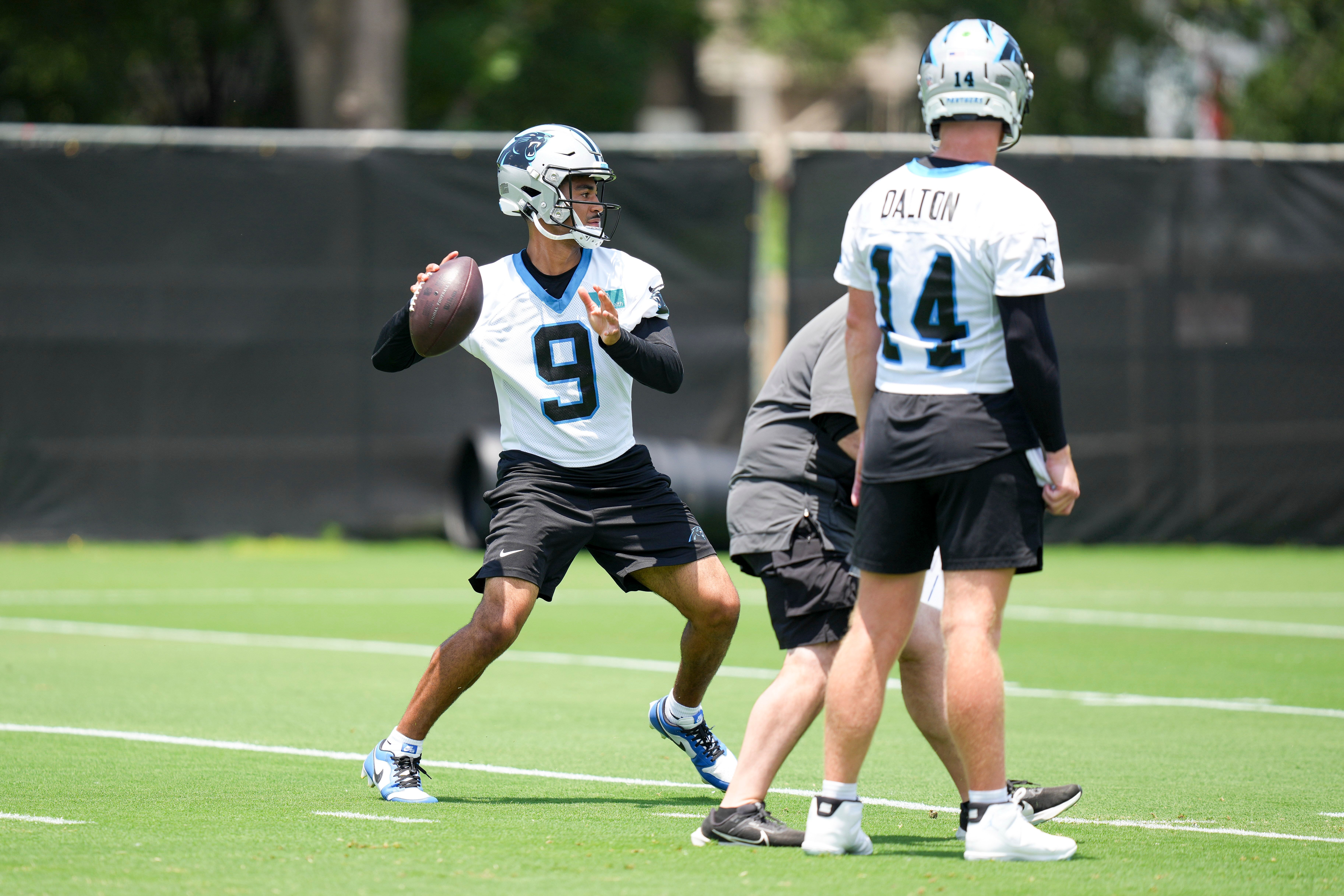 Jun 11, 2025; Charlotte, NC, USA; Carolina Panthers quarterback Andy Dalton (14) watches quarterback Bryce Young (9) throw during minicamp at Bank of America Stadium.