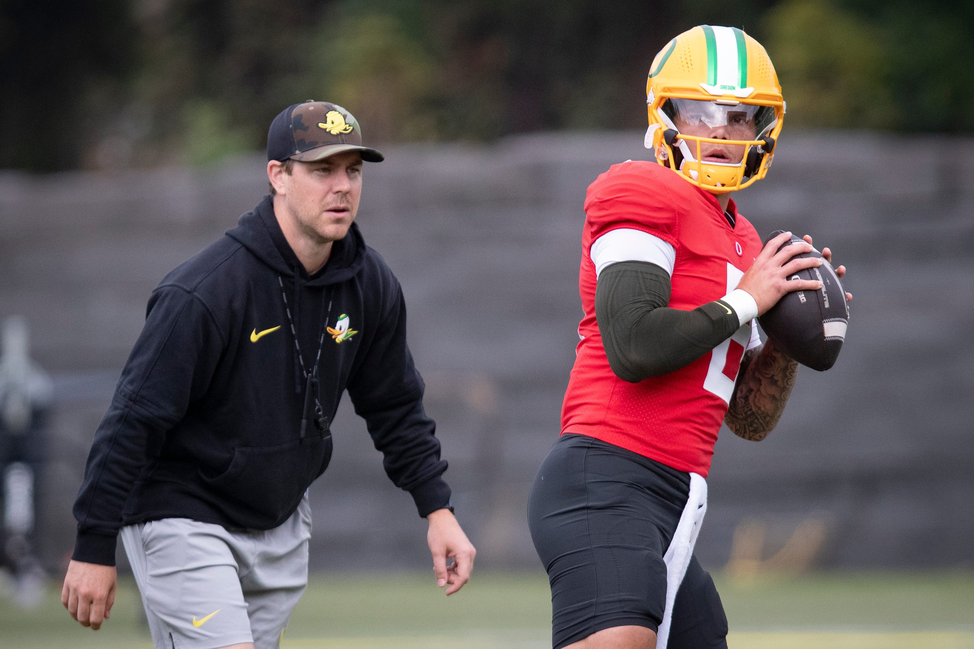 Oregon quarterback Dillon Gabriel throws out a pass as offensive coordinator Will Stein during practice with the Oregon Ducks Tuesday, Aug. 27, 2024 at the Hatfield-Dowlin Complex in Eugene, Ore.