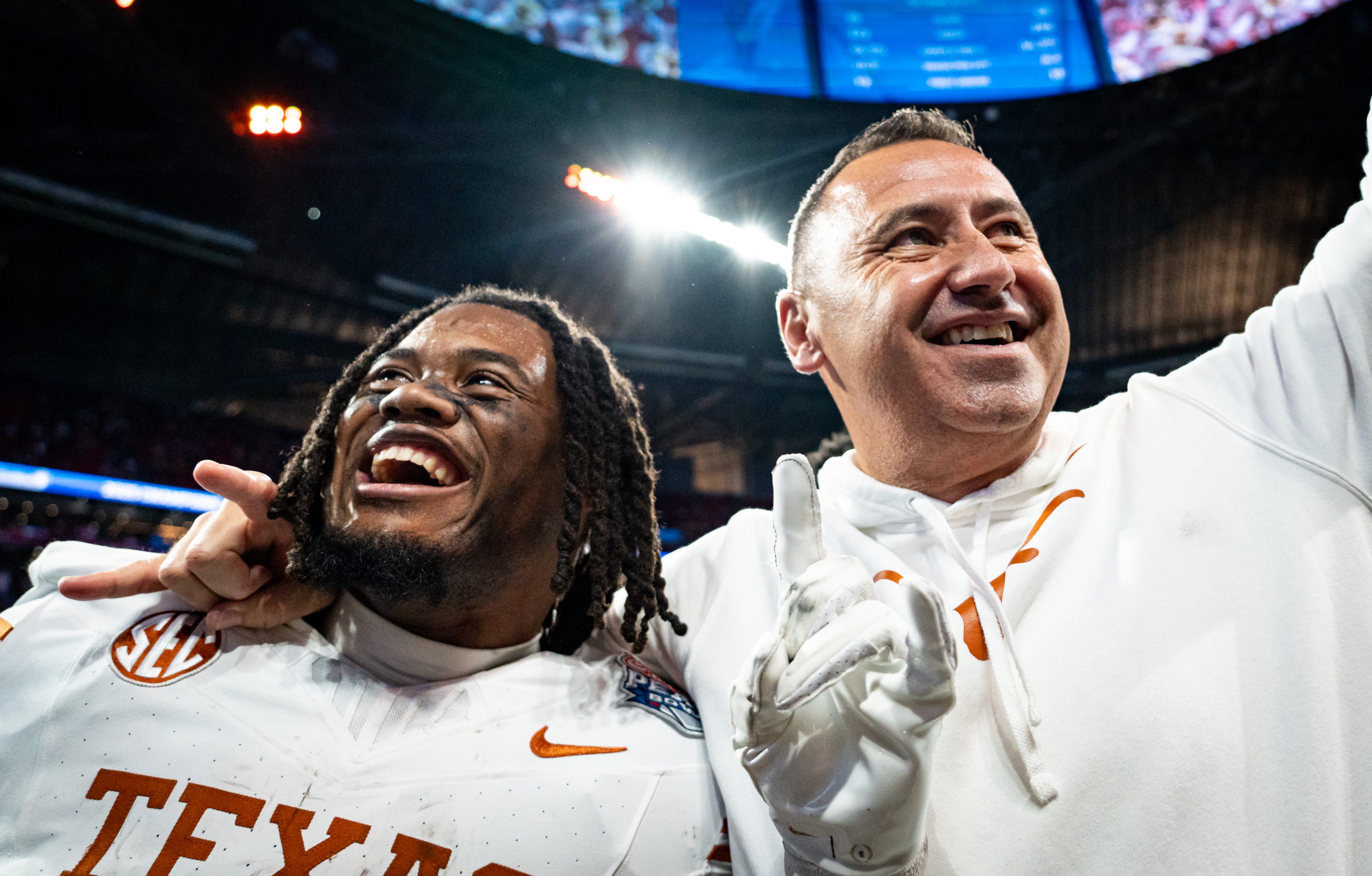Texas Longhorns running back Jaydon Blue (23) and head coach Steve Sarkisian celebrate the Longhorns 39-31 double overtime win over the Arizona State Sun Devils in the Peach Bowl College Football Playoff quarterfinal at Mercedes-Benz Stadium in Atlanta, Georgia, Jan. 1, 2025.