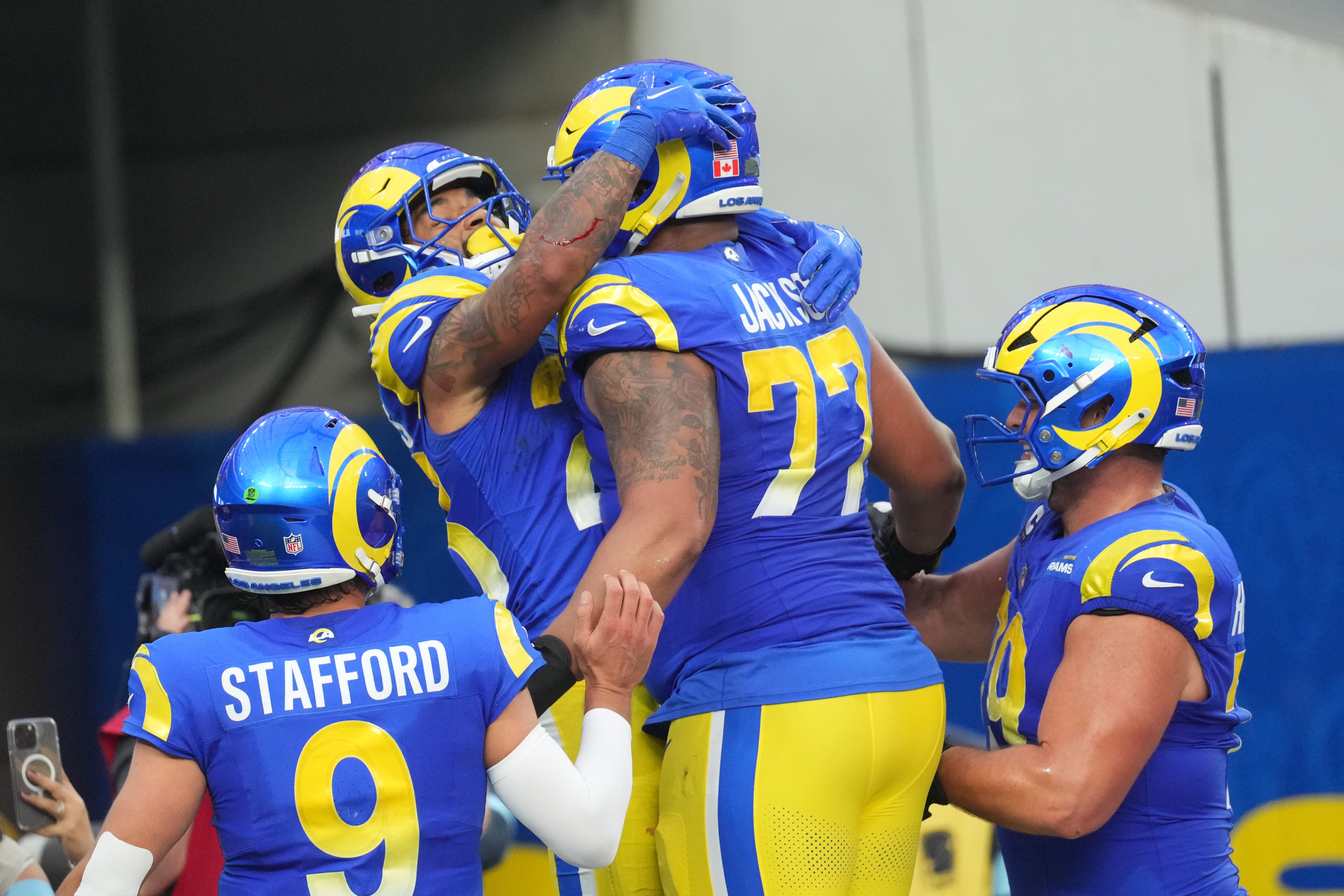 Dec 8, 2024; Inglewood, California, USA; Los Angeles Rams running back Kyren Williams (23) celebrates with quarterback Matthew Stafford (9) and offensive tackle Alaric Jackson (77) after scoring in a 7-yard touchdown run against the Buffalo Bills in the third quarter at SoFi Stadium.
