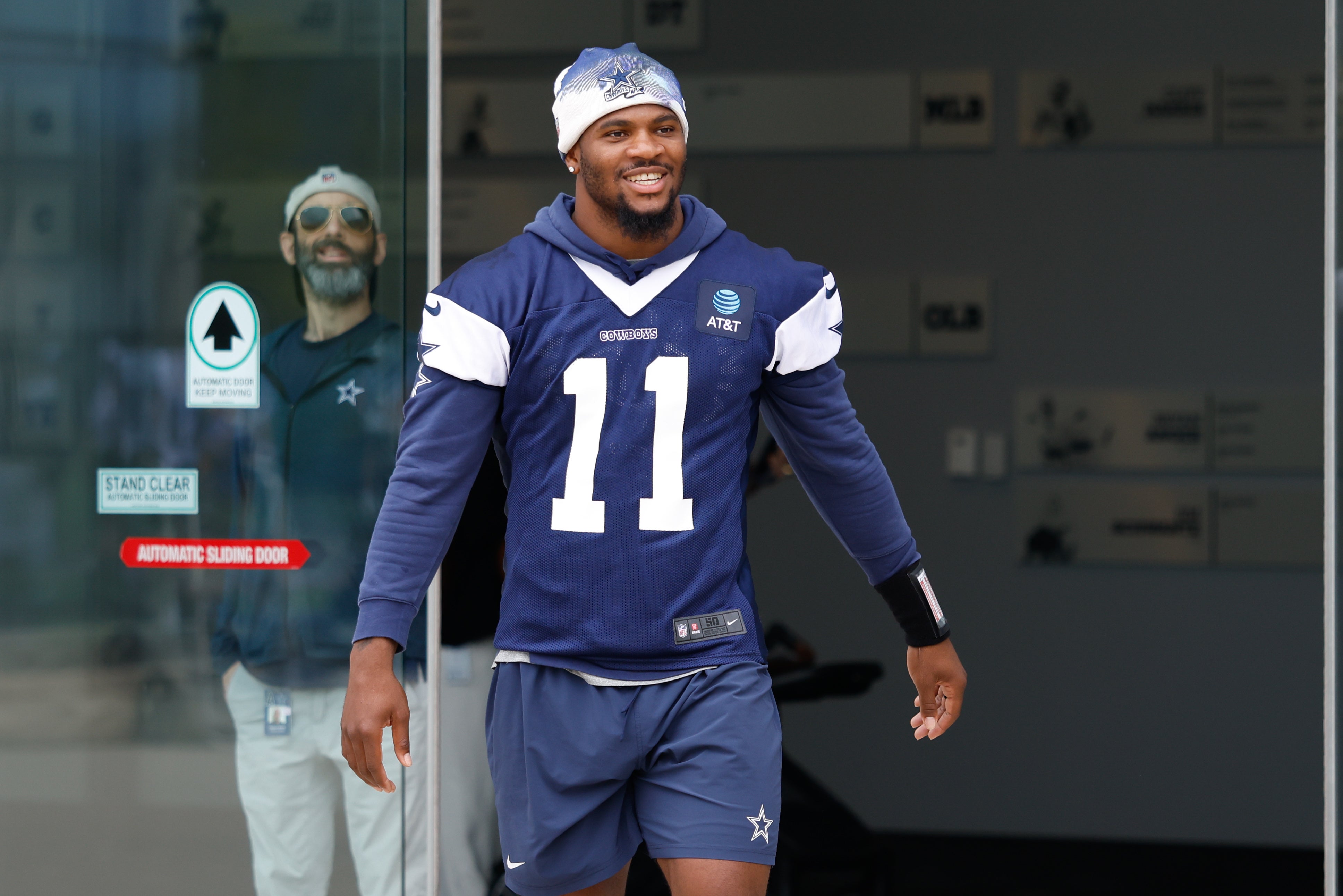 Dallas Cowboys defensive end Micah Parsons (11) walks onto the practice field at the Ford Center at the Star Training Facility in Frisco, Texas.