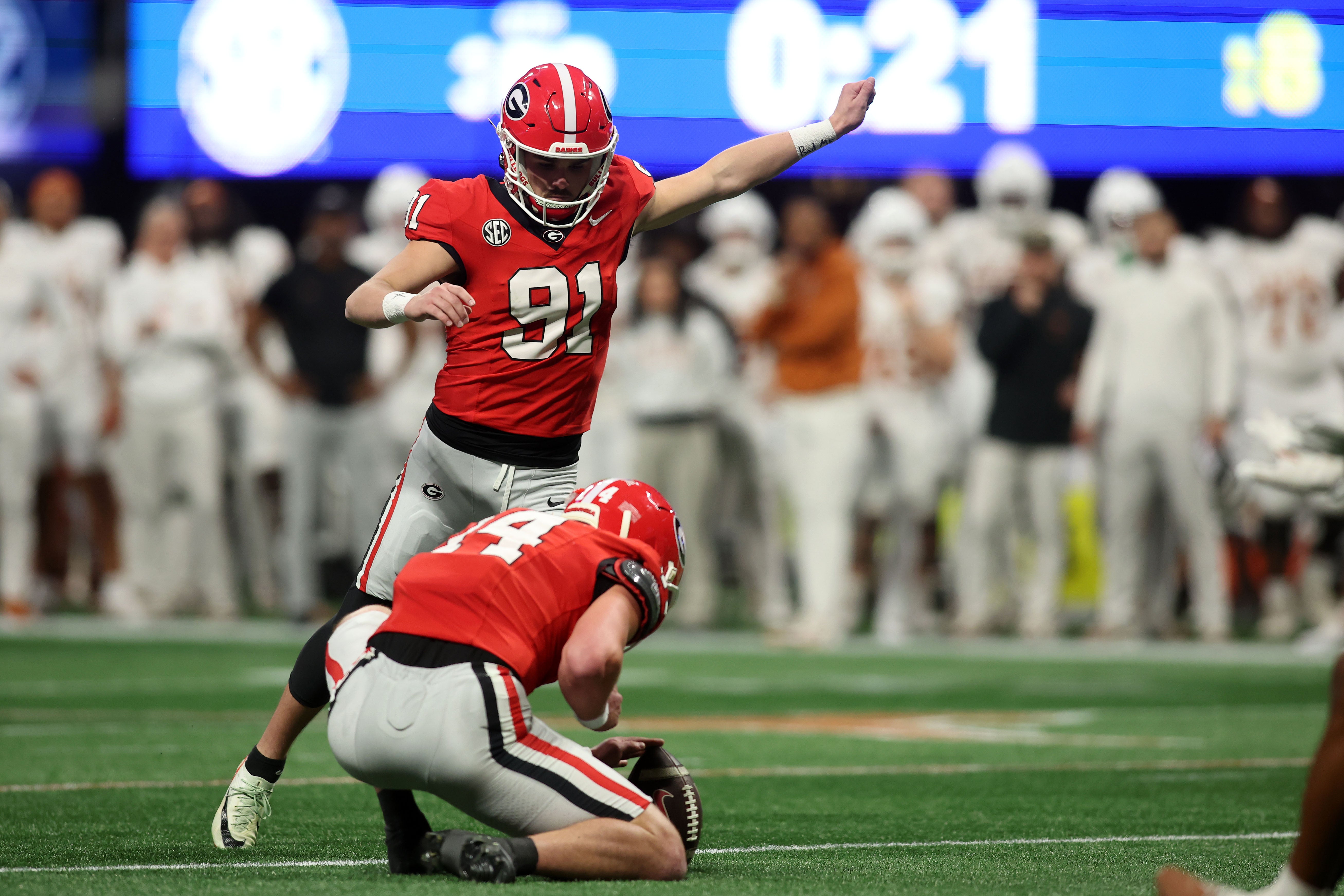 Georgia Bulldogs place kicker Peyton Woodring (91) kicks a field goal against the Texas Longhorns during the second half in the 2024 SEC Championship game at Mercedes-Benz Stadium.