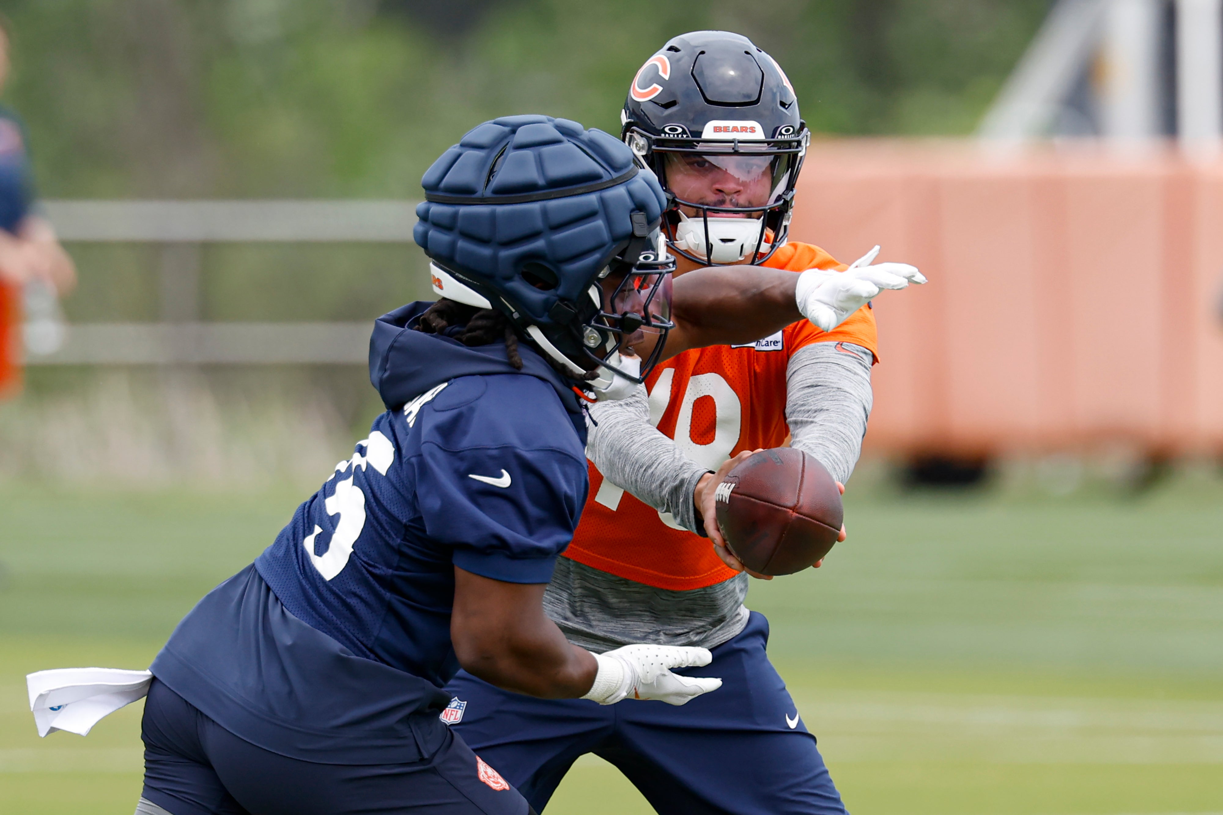 Jun 3, 2025; Lake Forest, IL, USA; Chicago Bears quarterback Caleb Williams (18) passes the ball to running back Kyle Monangai (25) during minicamp at Halas Hall.