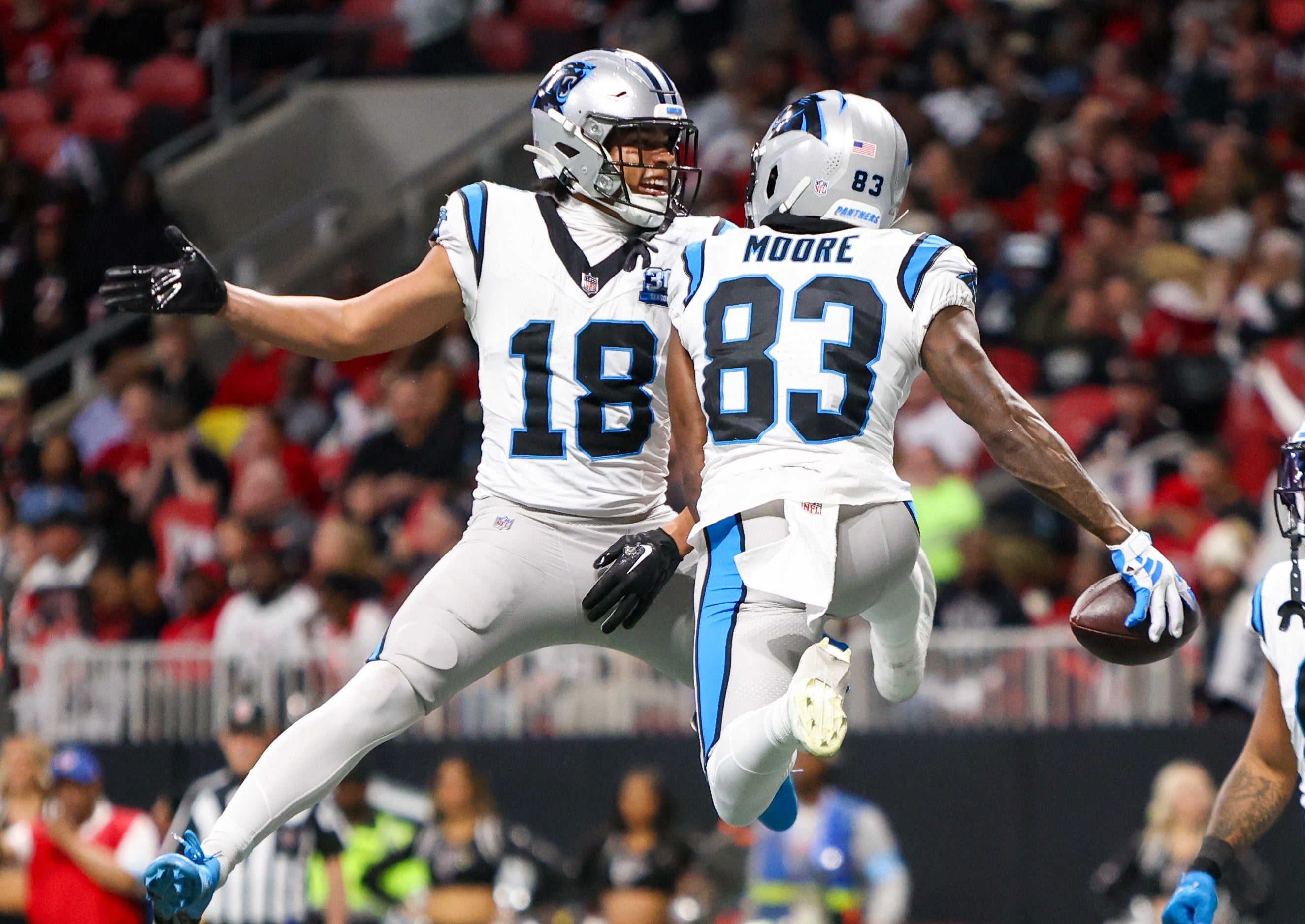Jan 5, 2025; Atlanta, Georgia, USA; Carolina Panthers wide receiver Jalen Coker (18) celebrates with wide receiver David Moore (83) after a catch for a touchdown.