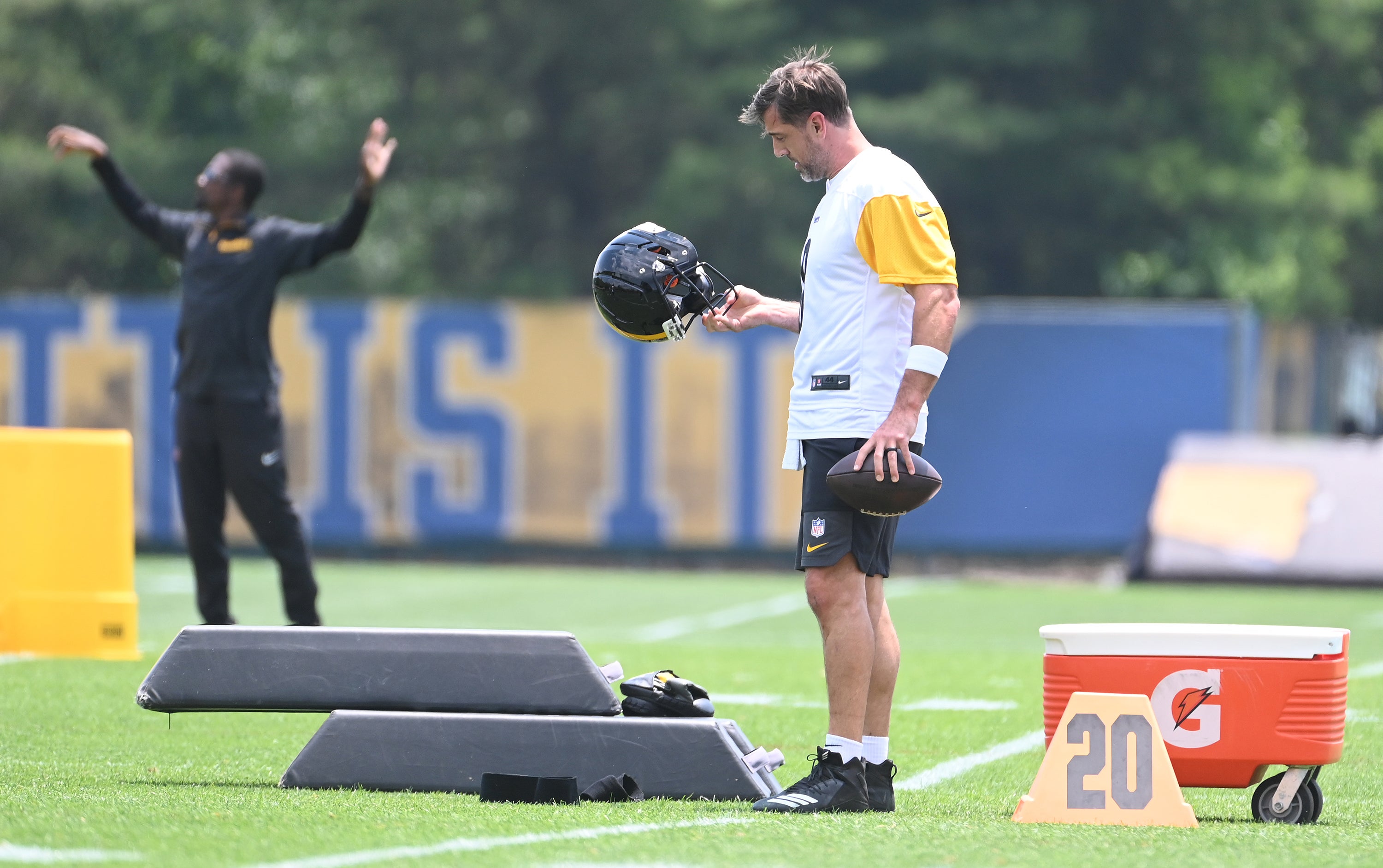 Jun 10, 2025; Pittsburgh, PA, USA; Pittsburgh Steelers quarterback Aaron Rodgers (8) looks over his helmet during minicamp at their South Side facility.