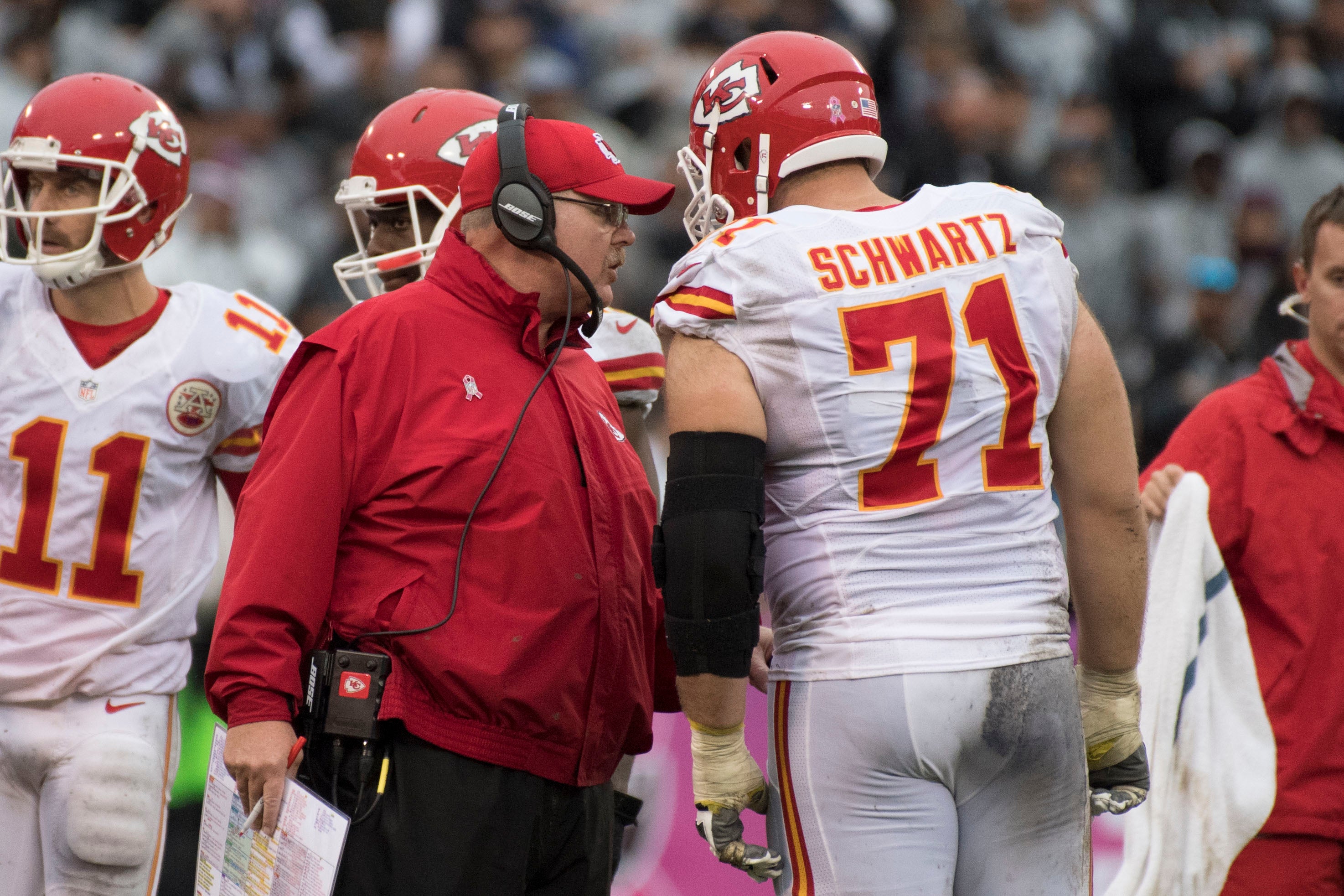 October 16, 2016; Oakland, CA, USA; Kansas City Chiefs head coach Andy Reid (center) instructs offensive tackle Mitchell Schwartz (71) during the third quarter against the Oakland Raiders at Oakland Coliseum. The Chiefs defeated the Raiders 26-10.