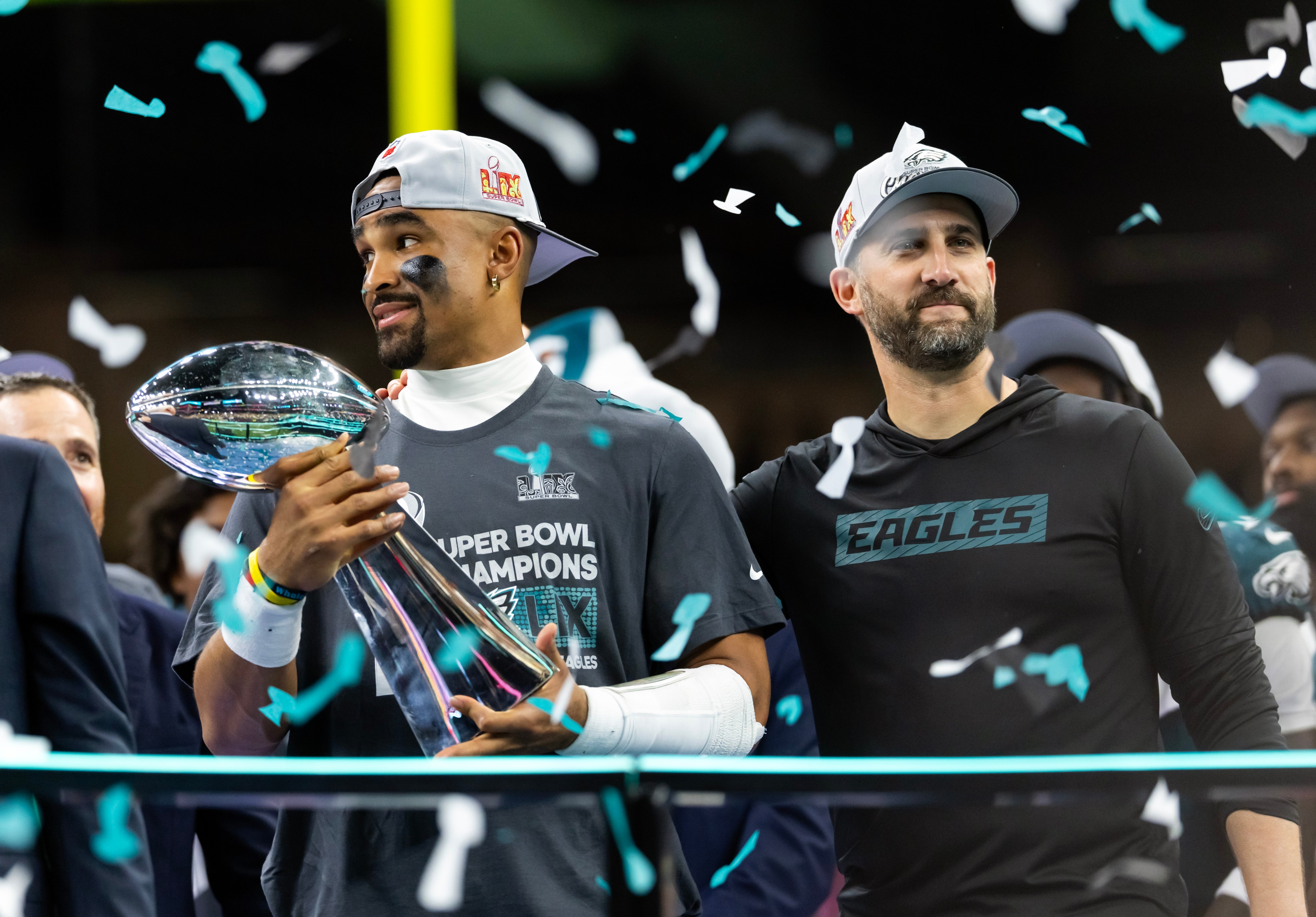 Philadelphia Eagles quarterback Jalen Hurts (left) and head coach Nick Sirianni celebrate with the Vince Lombardi Trophy after defeating the Kansas City Chiefs during Super Bowl LIX at Ceasars Superdome.