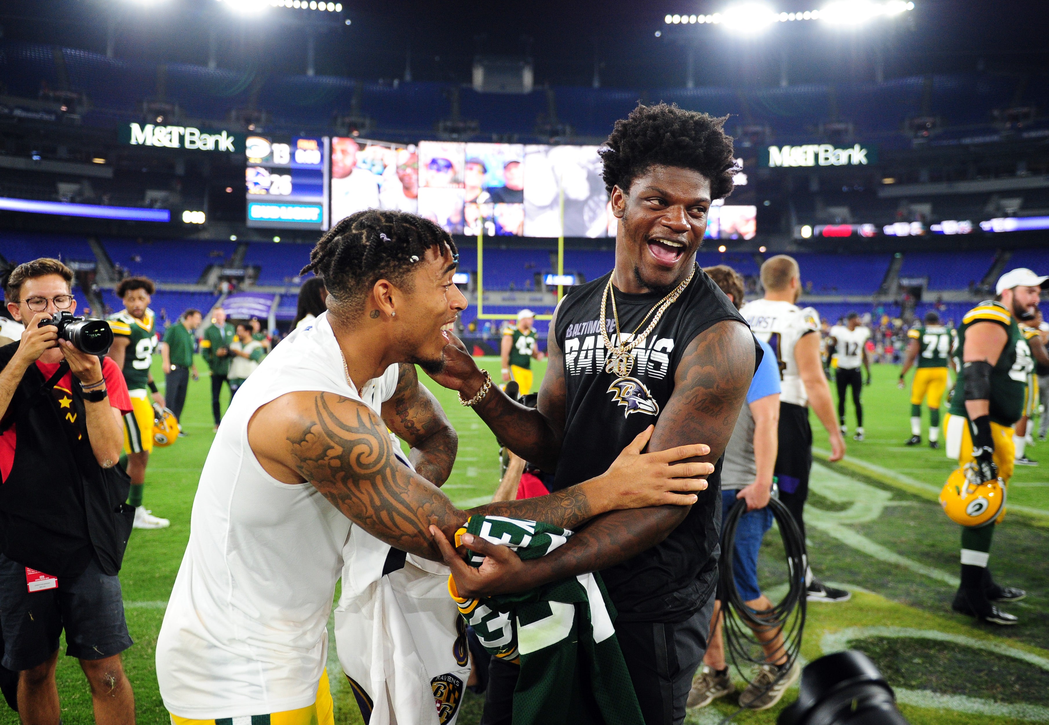 Baltimore Ravens quarterback Lamar Jackson (right) talks to Green Bay Packers cornerback Jaire Alexander (left) after the game at M&T Bank Stadium.