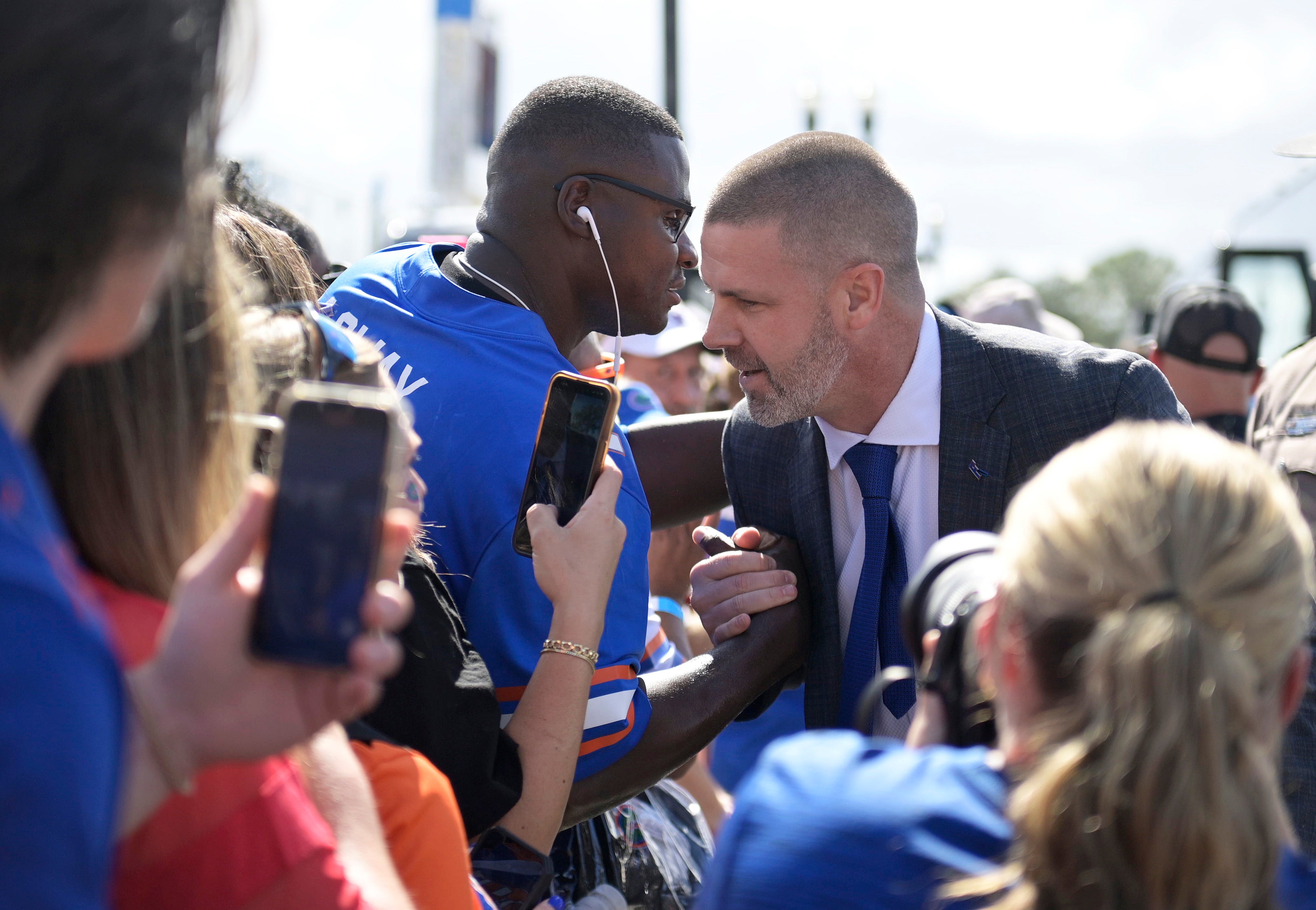 Nov 2, 2024; Jacksonville, Florida, USA; Florida Gators head coach Billy Napier meets with the father of quarterback DJ Lagway (2) before the game against the Georgia Bulldogs at EverBank Stadium.