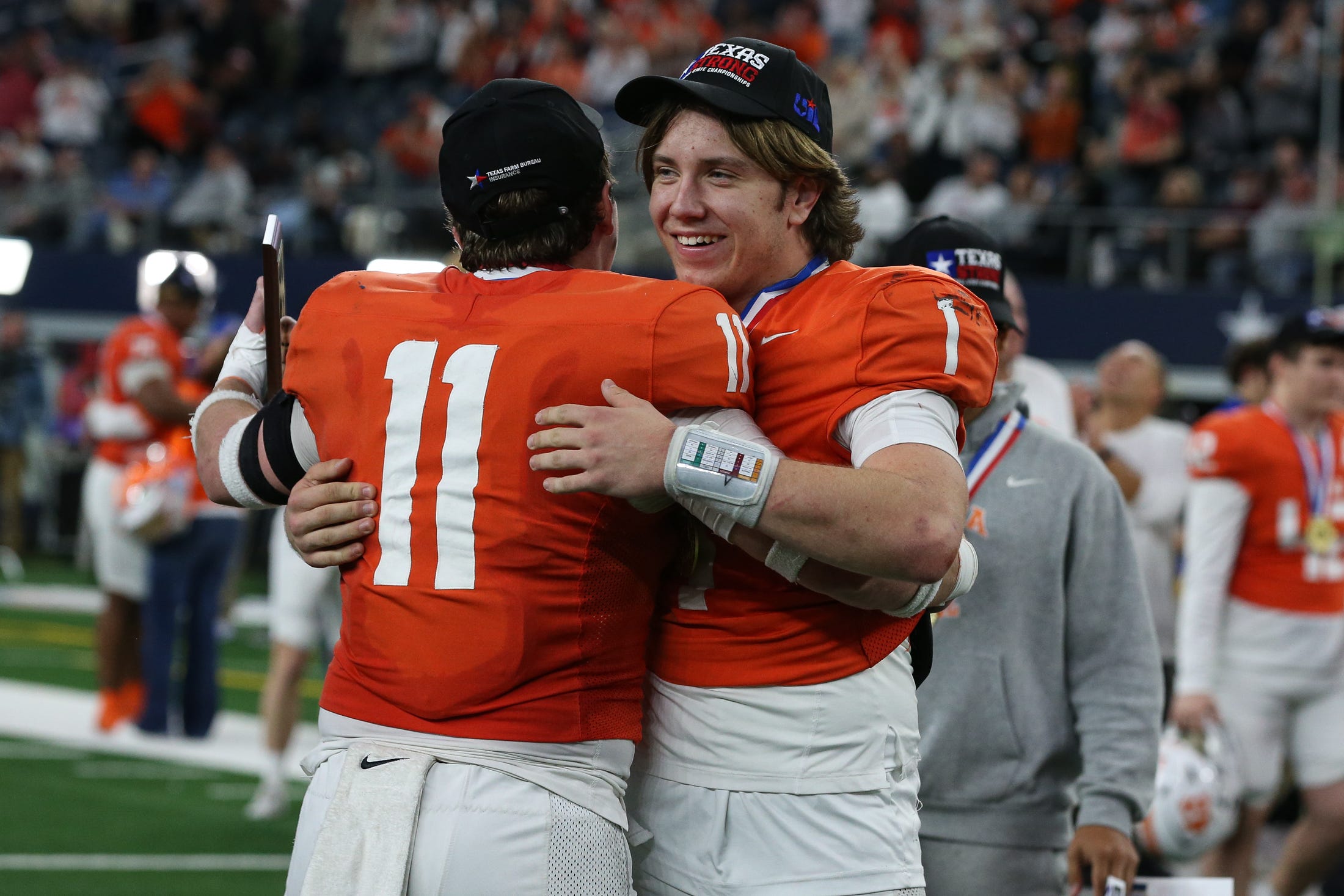 Celina's Luke Biagini (11), the defensive MVP, hugs Bowe Bentley, the offensive MVP, after the Class 4A, Division I State Championship game on Friday, Dec. 20, 2024, at AT&T Stadium in Arlington, Texas.