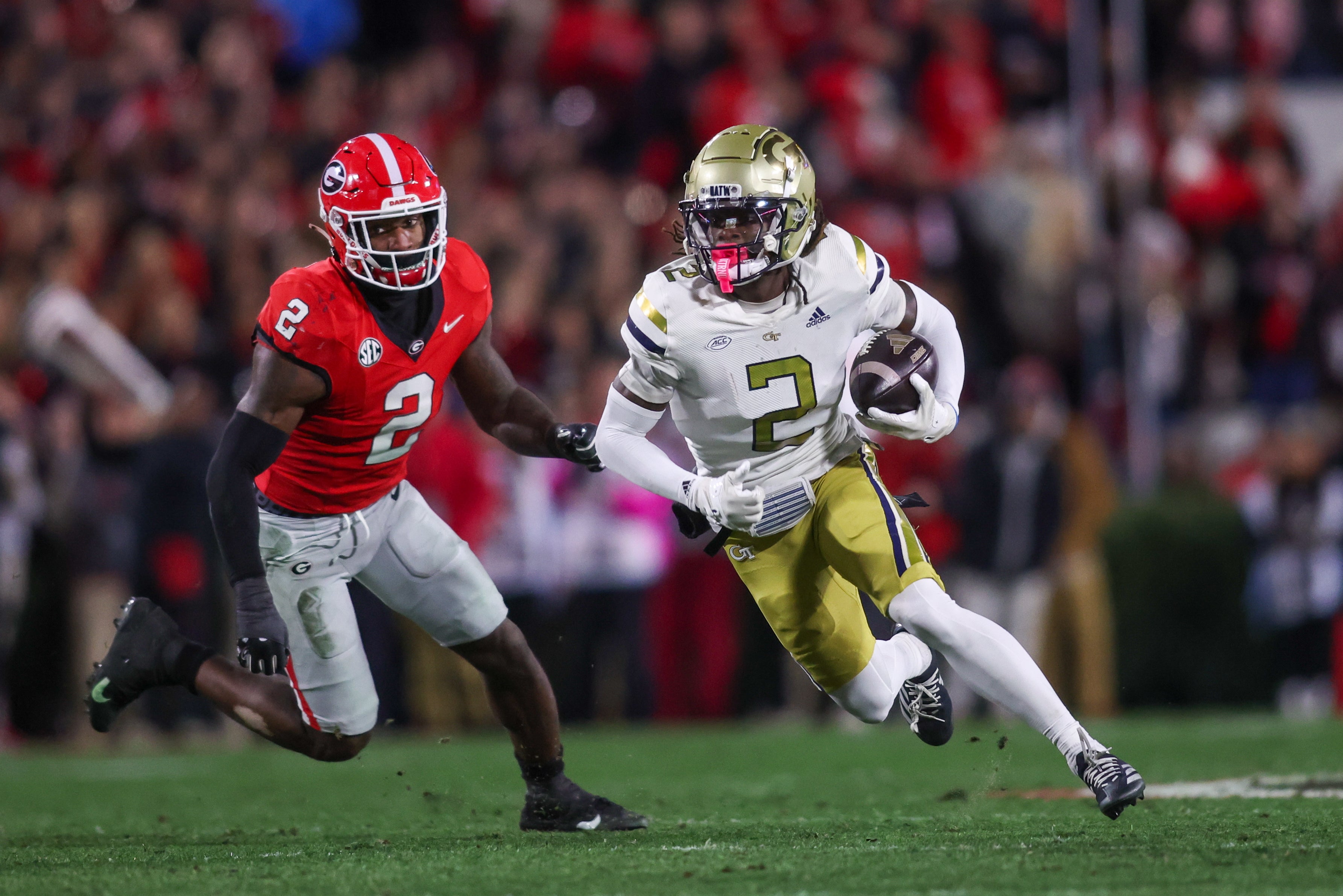 Georgia Tech Yellow Jackets wide receiver Eric Singleton Jr. (2) runs past Georgia Bulldogs linebacker Smael Mondon Jr. (2) in the first quarter at Sanford Stadium.