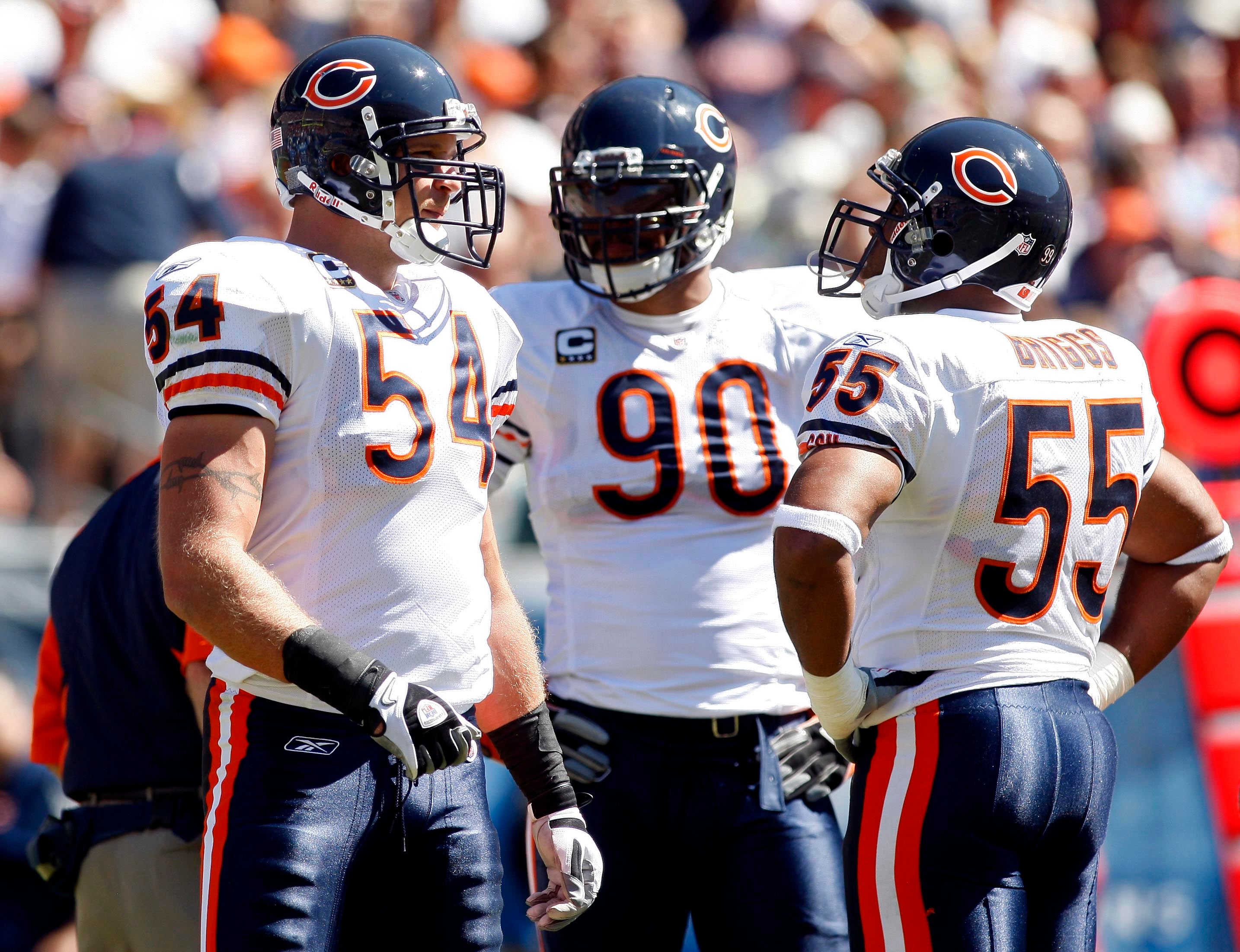Sep 12, 2010; Chicago, IL, USA; Chicago Bears linebacker Brian Urlacher (54) talks with teammates Julius Peppers (90) and Lance Briggs (55) during the second quarter against the Detroit Lions at Soldier Field. The Bears won 19-14.