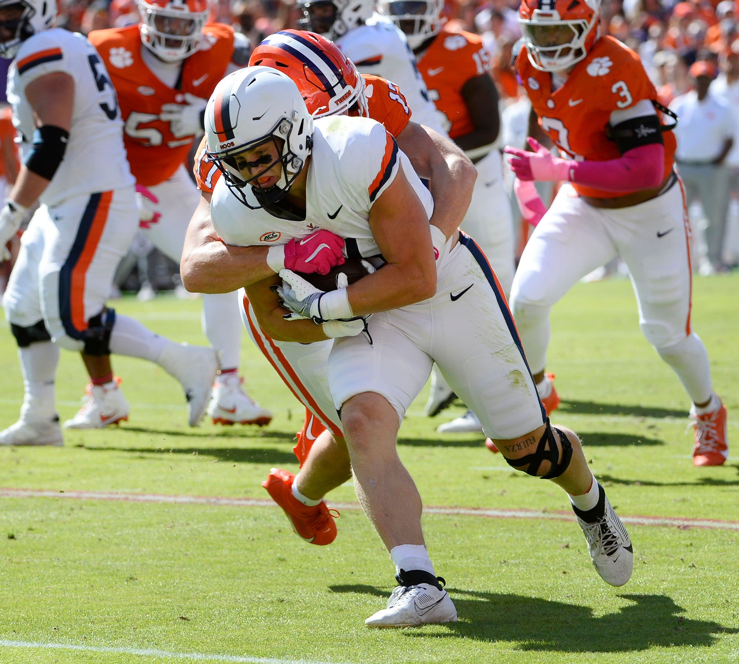 Virginia Cavaliers Tyler Neville (16) moves the ball down field against the Clemson Tigers at Memorial Stadium.