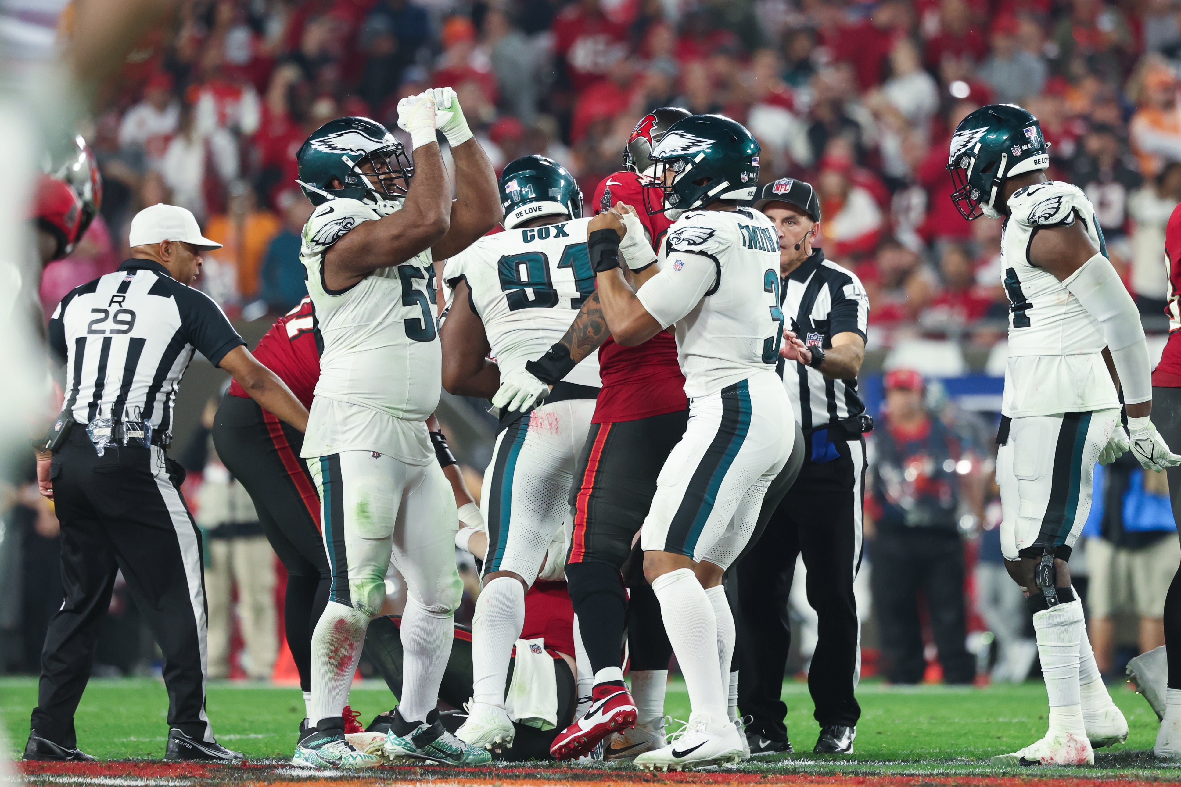 Jan 15, 2024; Tampa, Florida, USA; Philadelphia Eagles defensive end Brandon Graham (55) and linebacker Nolan Smith (3) celebrate a sack on Tampa Bay Buccaneers quarterback Baker Mayfield (6) during the second half of a 2024 NFC wild card game at Raymond James Stadium. Mandatory Credit: Kim Klement Neitzel-Imagn Images