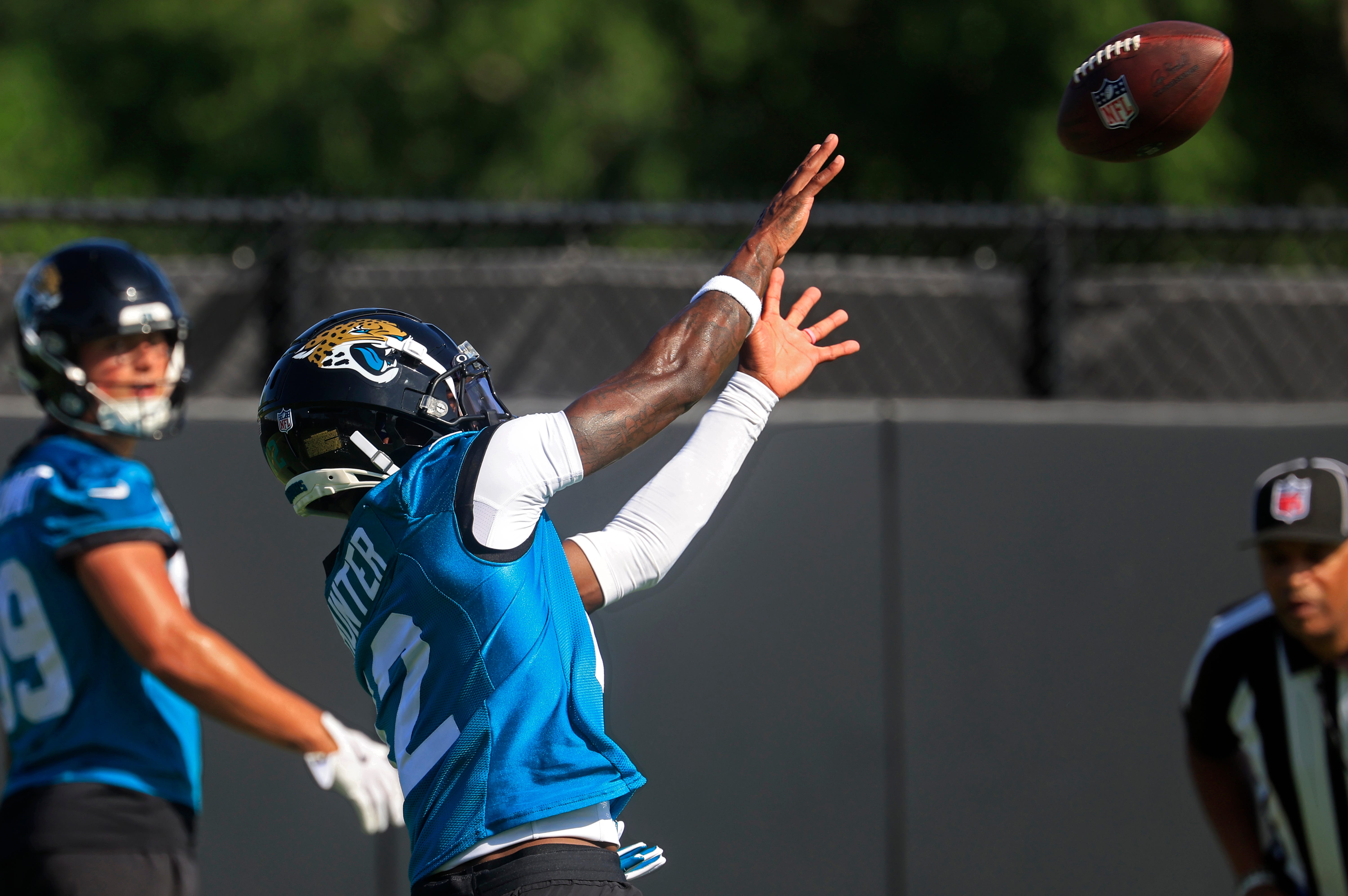 Jacksonville Jaguars wide receiver Travis Hunter (12) catches a pass as wide receiver Louis Rees-Zammit (89) looks on during the second mandatory minicamp at Miller Electric Center Wednesday, June 11, 2025 in Jacksonville, Fla.