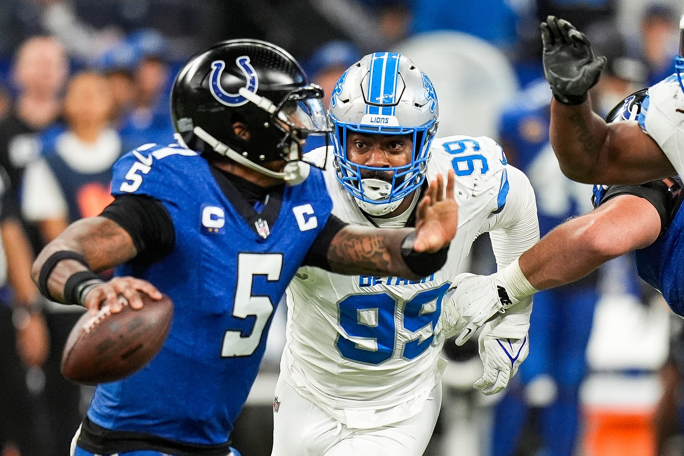 Detroit Lions defensive end Za'Darius Smith (99) pressures Indianapolis Colts quarterback Anthony Richardson (5) during the second half at Lucas Oil Stadium in Indianapolis, Ind. on Sunday, Nov. 24, 2024.