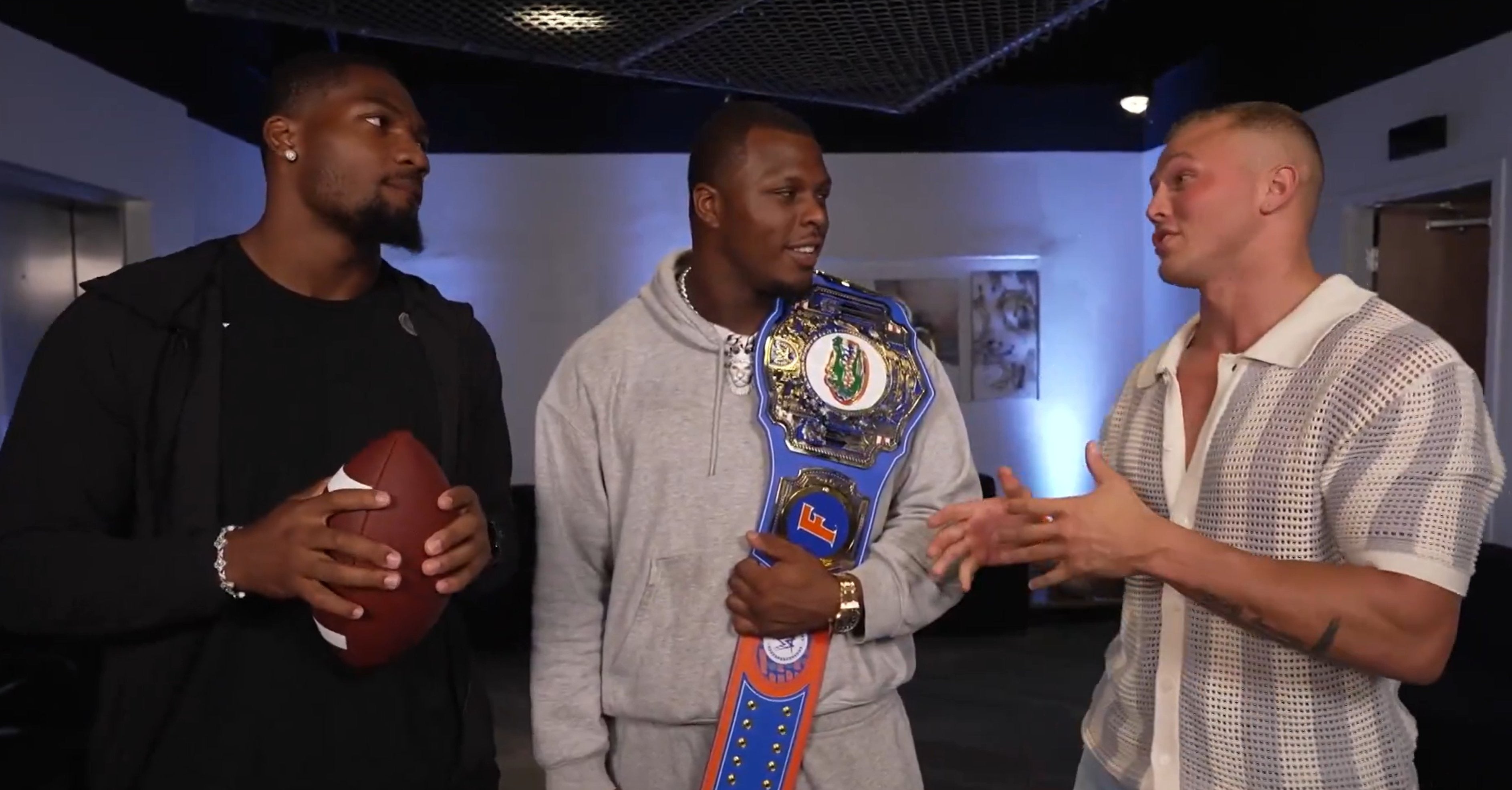 Florida Gators defensive linemen George Gumbs Jr. (left) and Tyreak Sapp (middle) talk with WWE wresler Myles Borne on Tuesday night's WWE NXT.