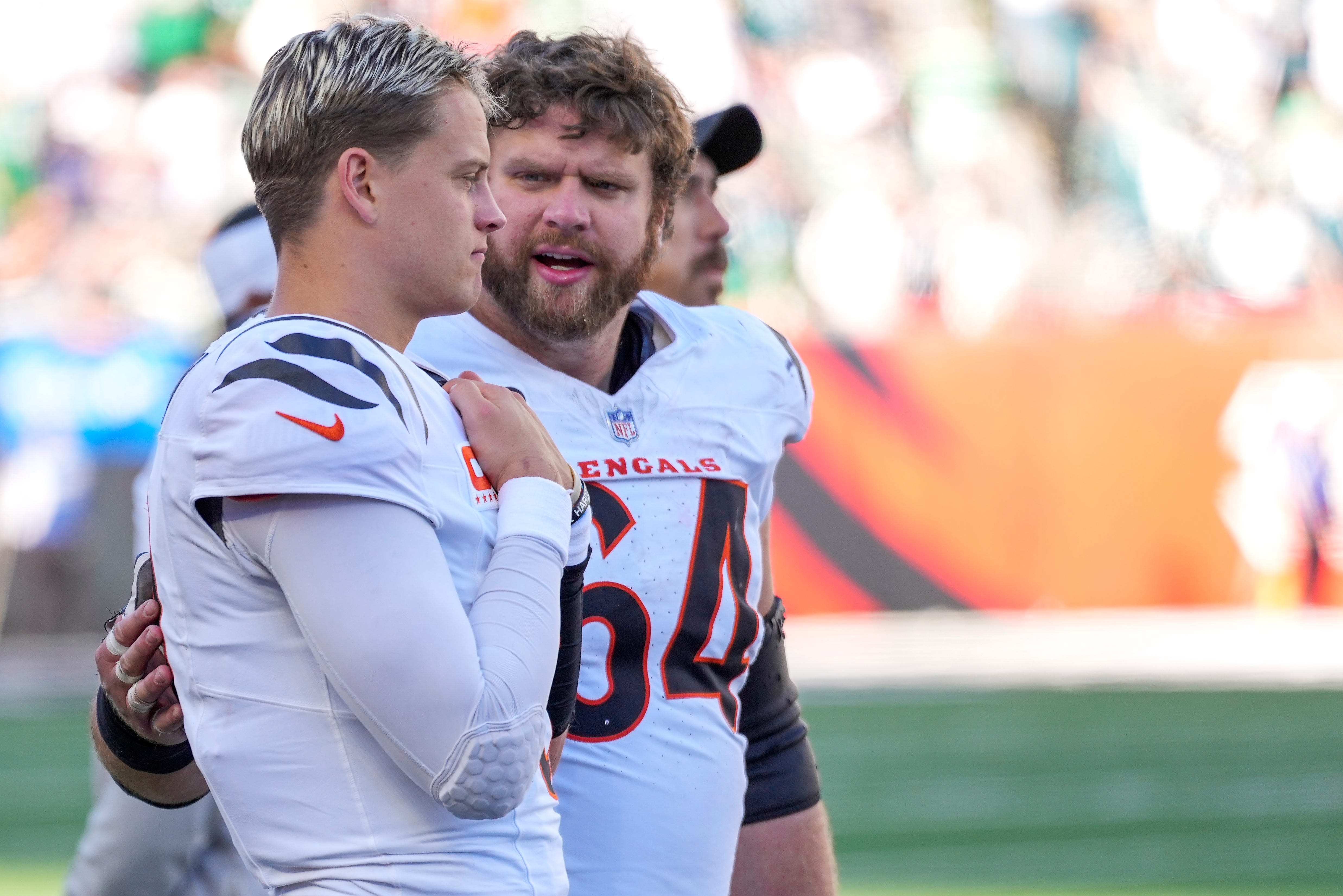 Cincinnati Bengals center Ted Karras (64) checks on quarterback Joe Burrow (9) after he leaves the game in the fourth quarter of the NFL Week 8 game between the Cincinnati Bengals and the Philadelphia Eagles at Paycor Stadium in downtown Cincinnati on Sunday, Oct. 27, 2024. The Bengals fell to 3-5 on the season with a 37-17 loss to the Eagles at home.
