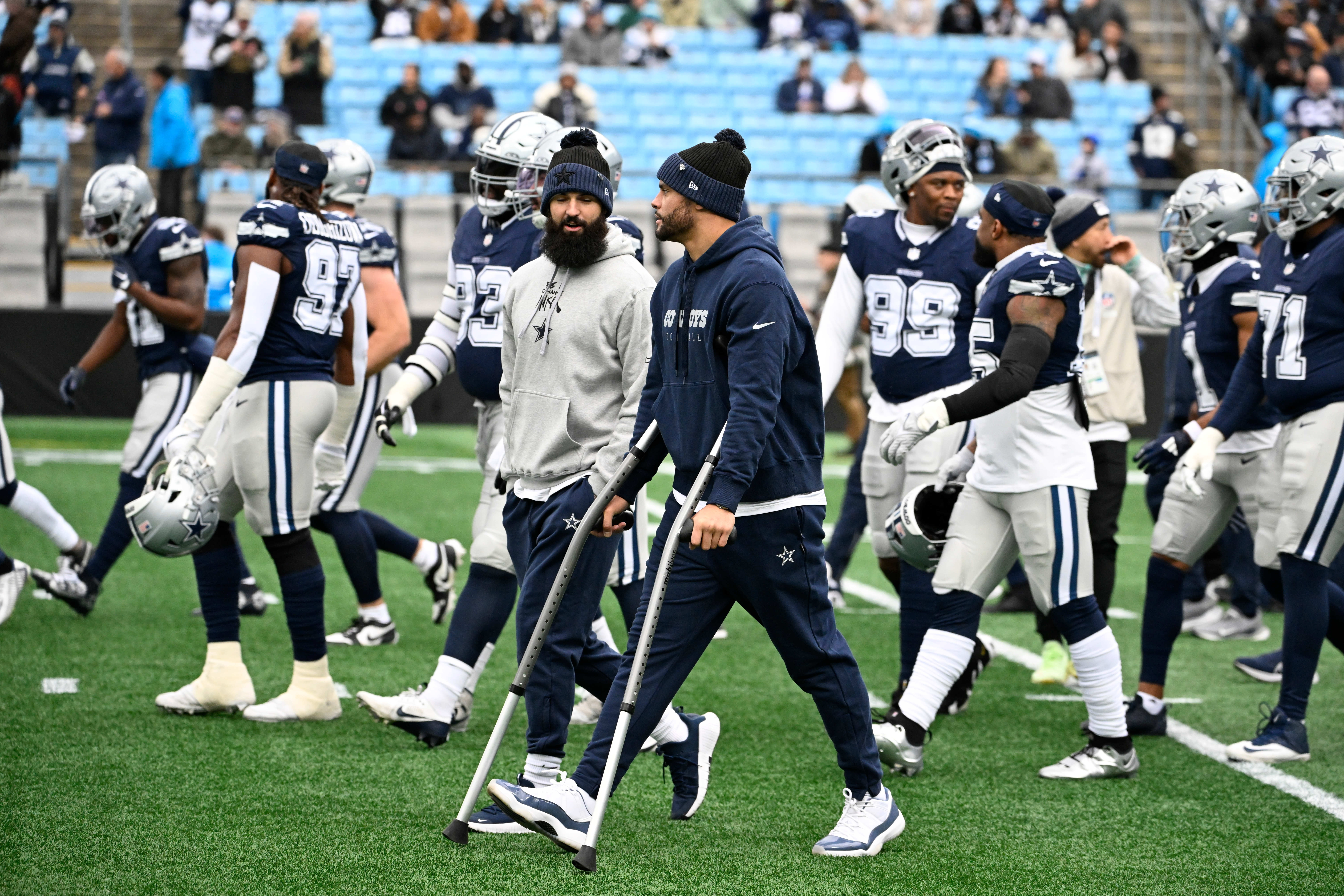 Dallas Cowboys quarterback Dak Prescott (4) walks off the field with the team before the game at Bank of America Stadium.