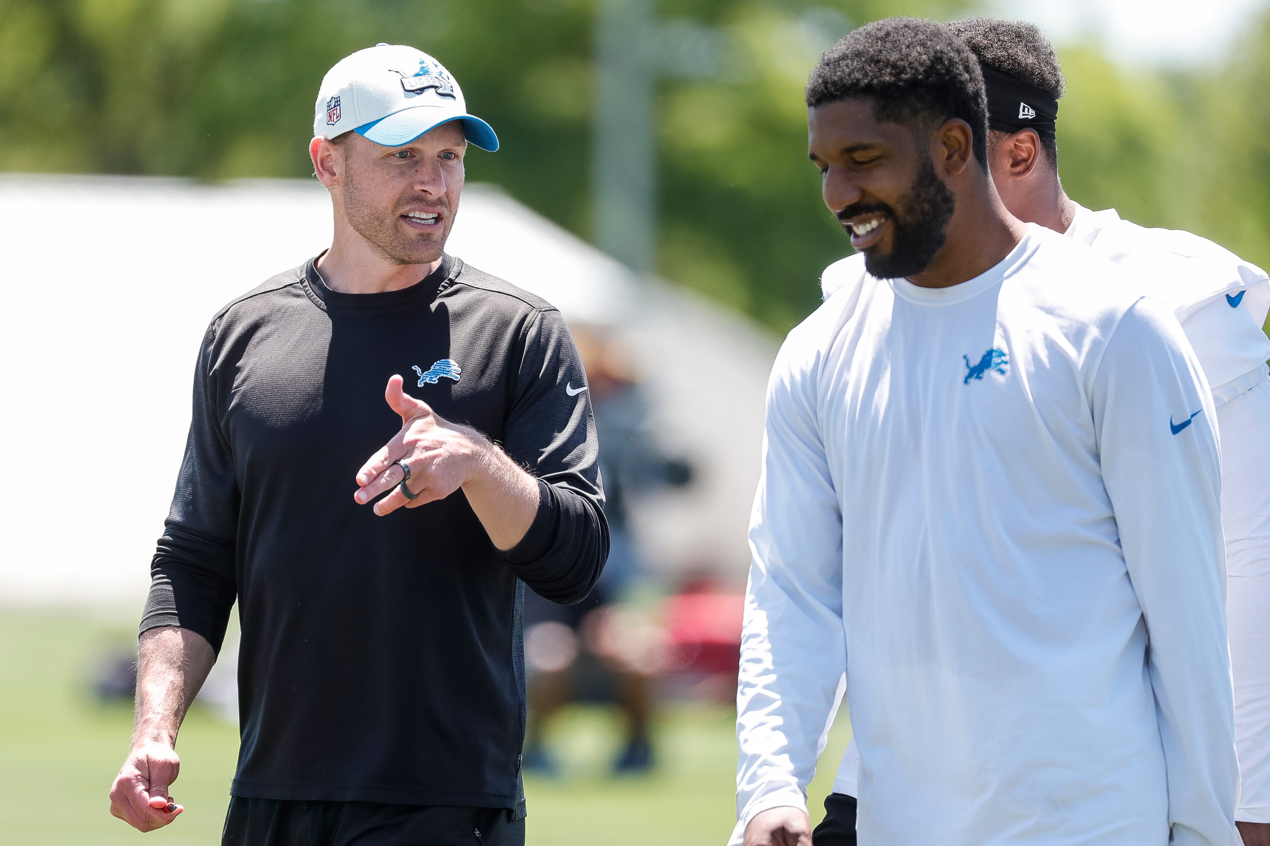 Detroit Lions offensive coordinator Ben Johnson talks to linebacker Jalen Reeves-Maybin (42) after practice during OTAs at Detroit Lions headquarters and training facility in Allen Park on Thursday, May 30, 2024.