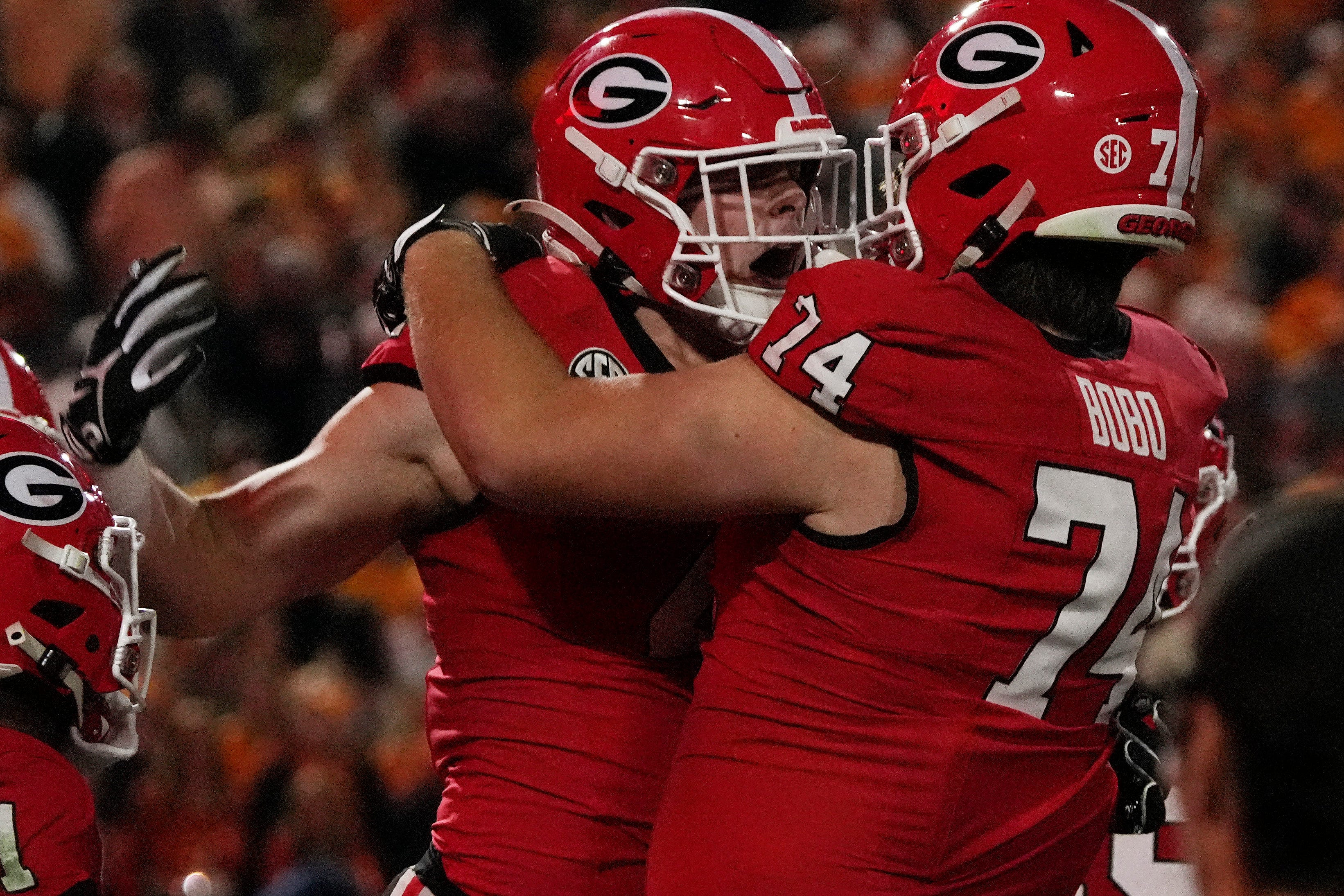 Georgia tight end Oscar Delp (4) celebrates with Georgia offensive lineman Drew Bobo (74) after scoring a touchdown during the first half of a NCAA college football game against Tennessee in Athens, Ga., on Saturday, Nov. 16, 2024.