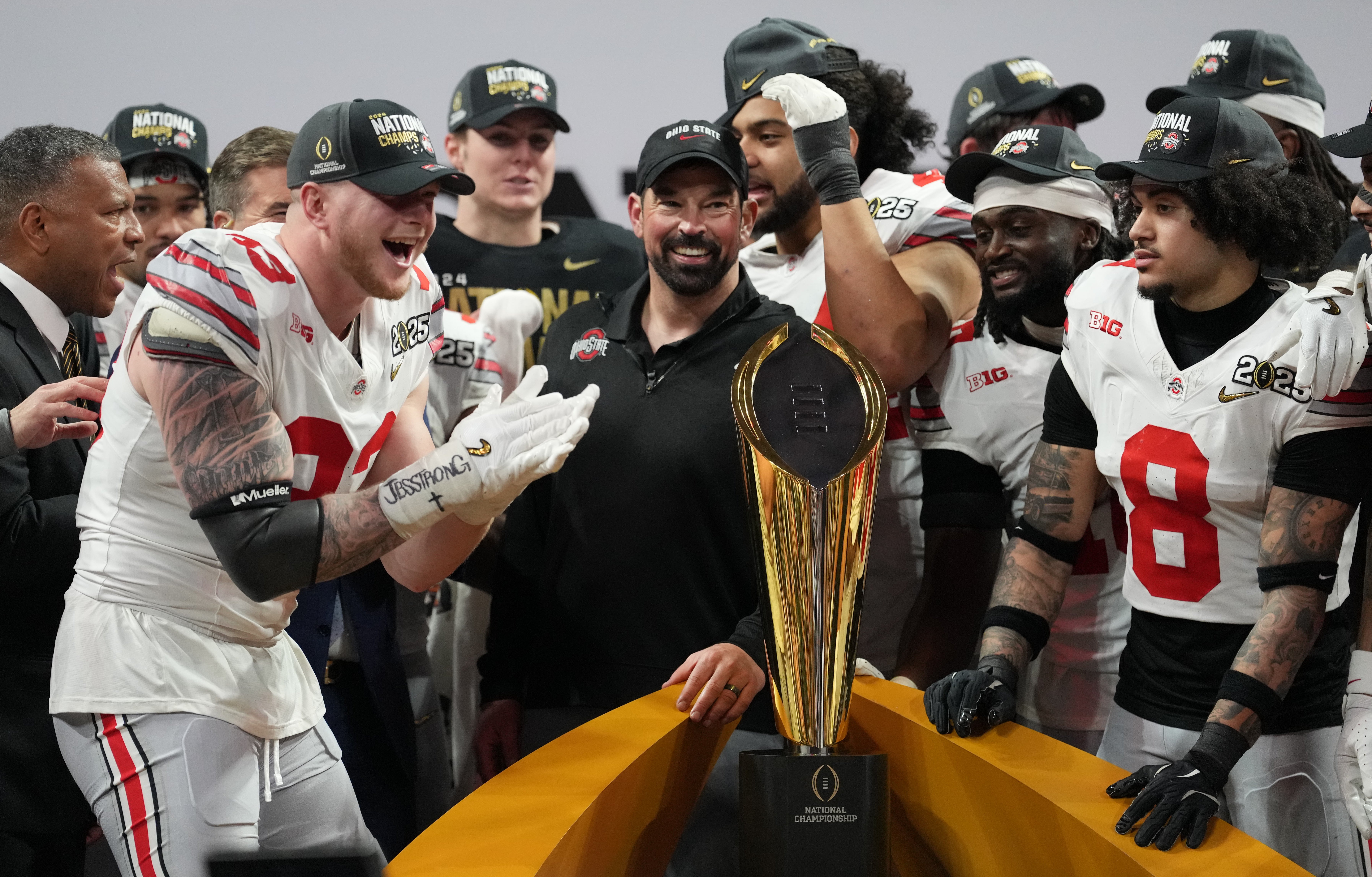 Jan 20, 2025; Atlanta, GA, USA; Ohio State Buckeyes defensive end Jack Sawyer (33) and Ohio State Buckeyes head coach Ryan Day celebrate on the podium after defeating the Notre Dame Fighting Irish in the CFP National Championship college football game at Mercedes-Benz Stadium.
