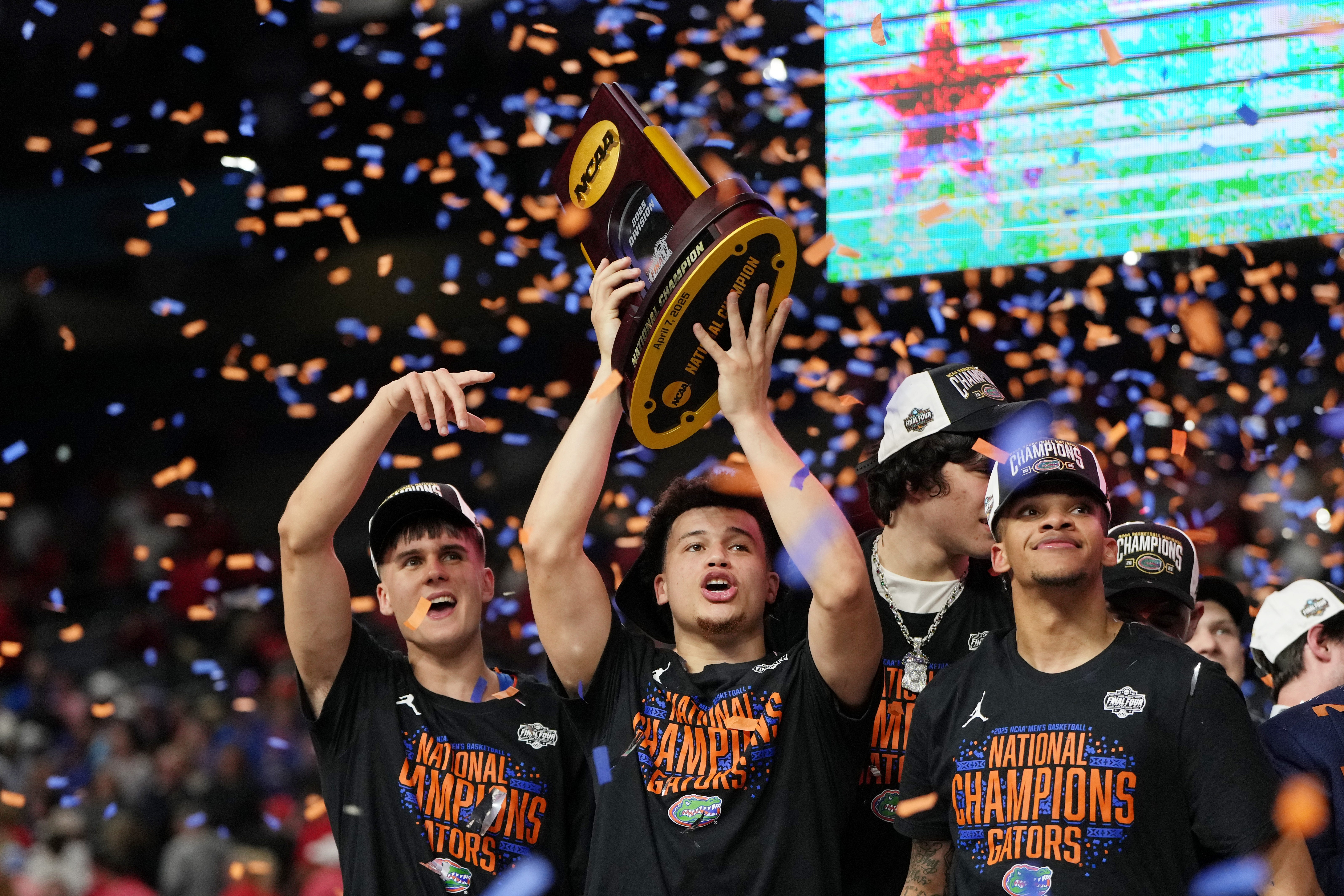 Apr 7, 2025; San Antonio, TX, USA; Florida Gators guard Walter Clayton Jr. (1) holds up the trophy after winning the national championship game of the Final Four of the 2025 NCAA Tournament at the Alamodome.