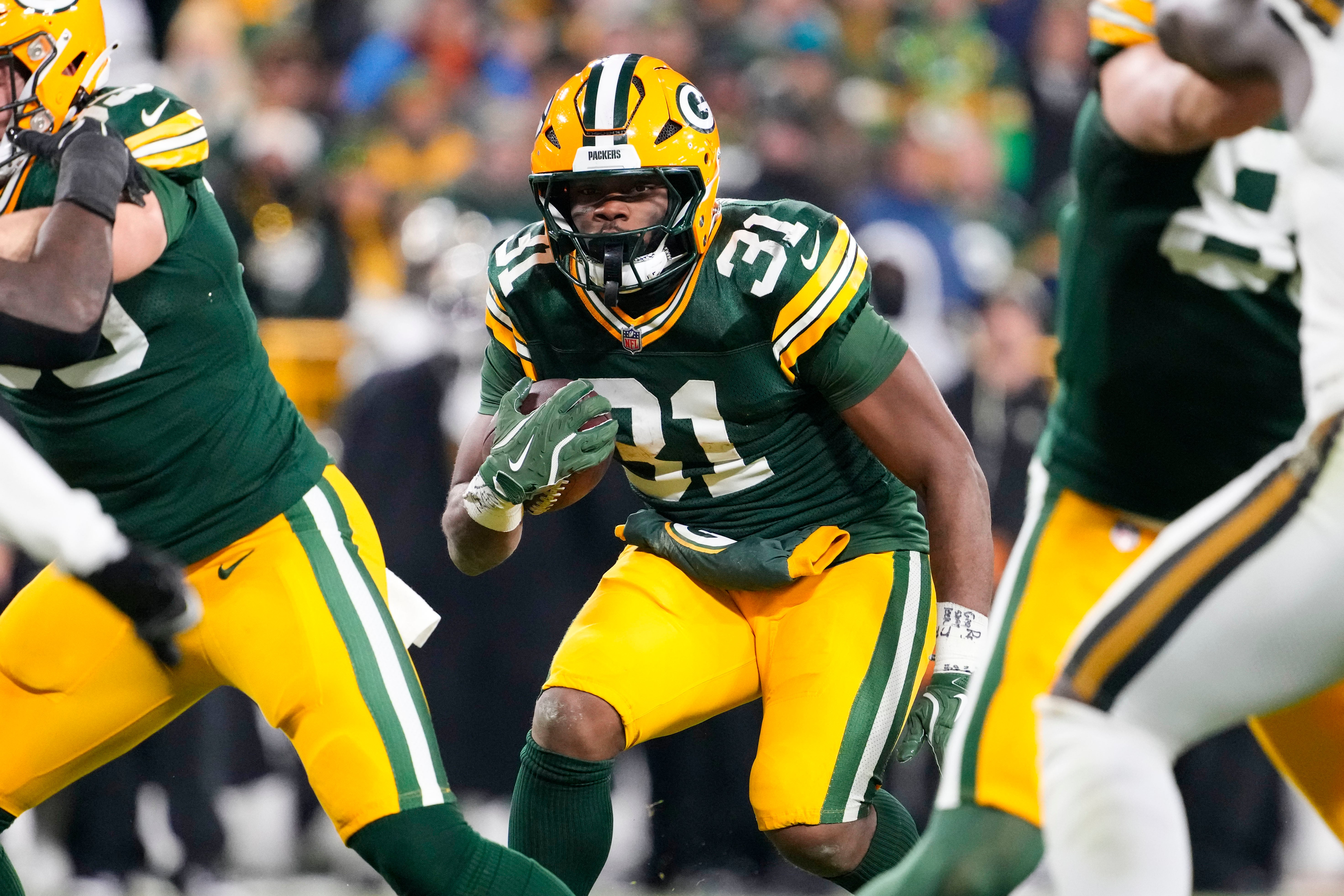 Green Bay Packers running back Emanuel Wilson (31) rushes with the football during the fourth quarter against the New Orleans Saints at Lambeau Field.